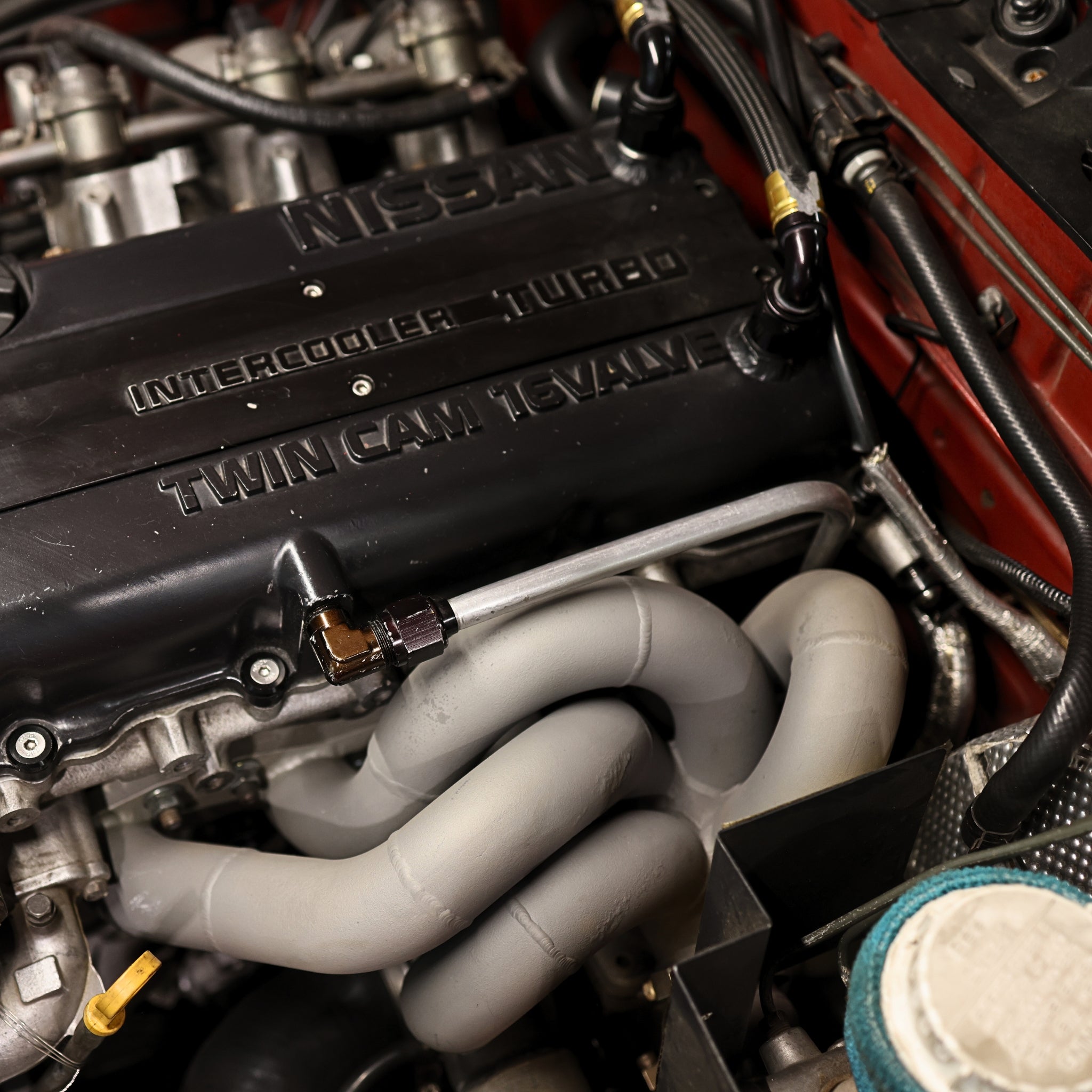 Close-up of a Nissan engine with 'Intercooler Turbo' and 'Twin Cam' text.