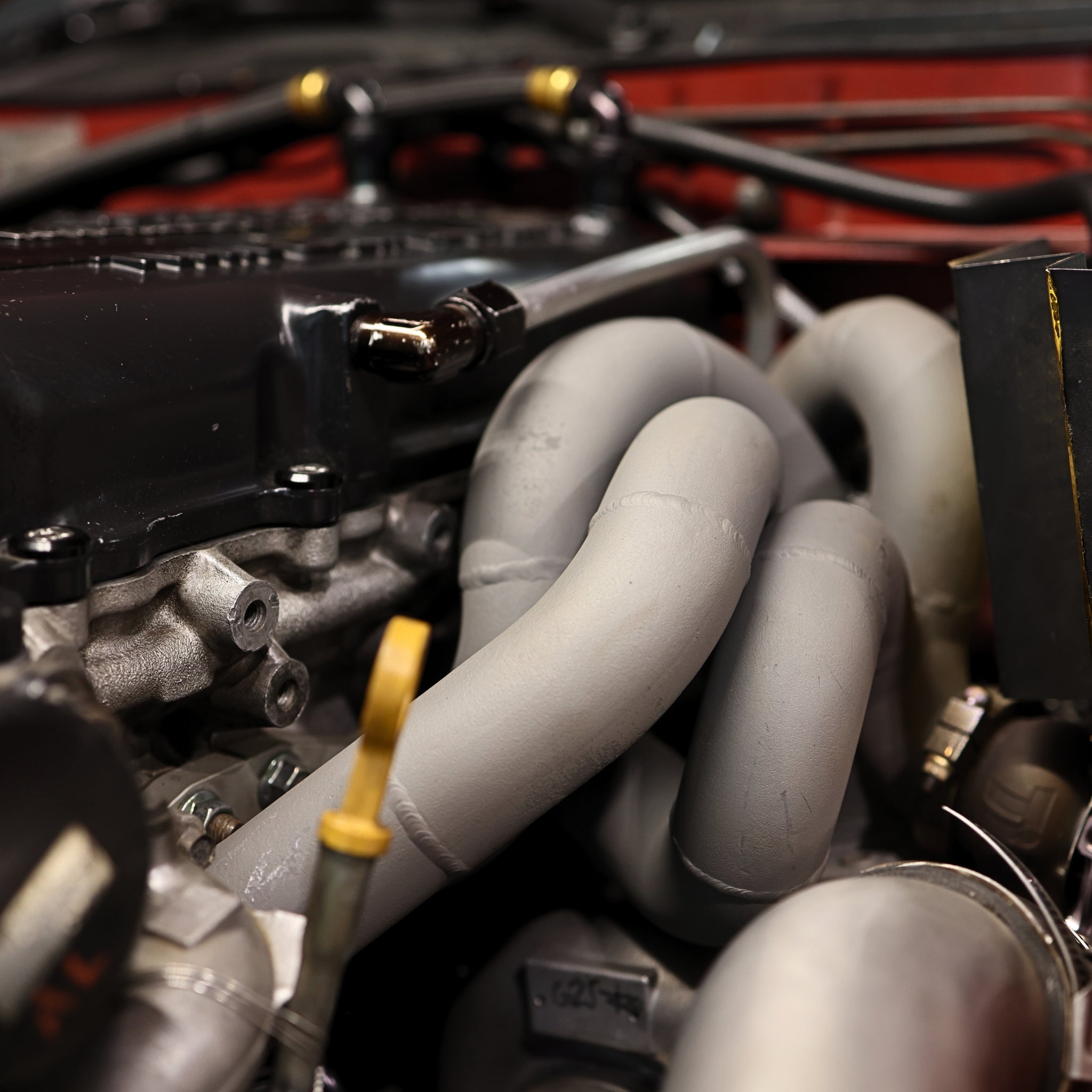 Close-up of a car engine with visible components and tools.