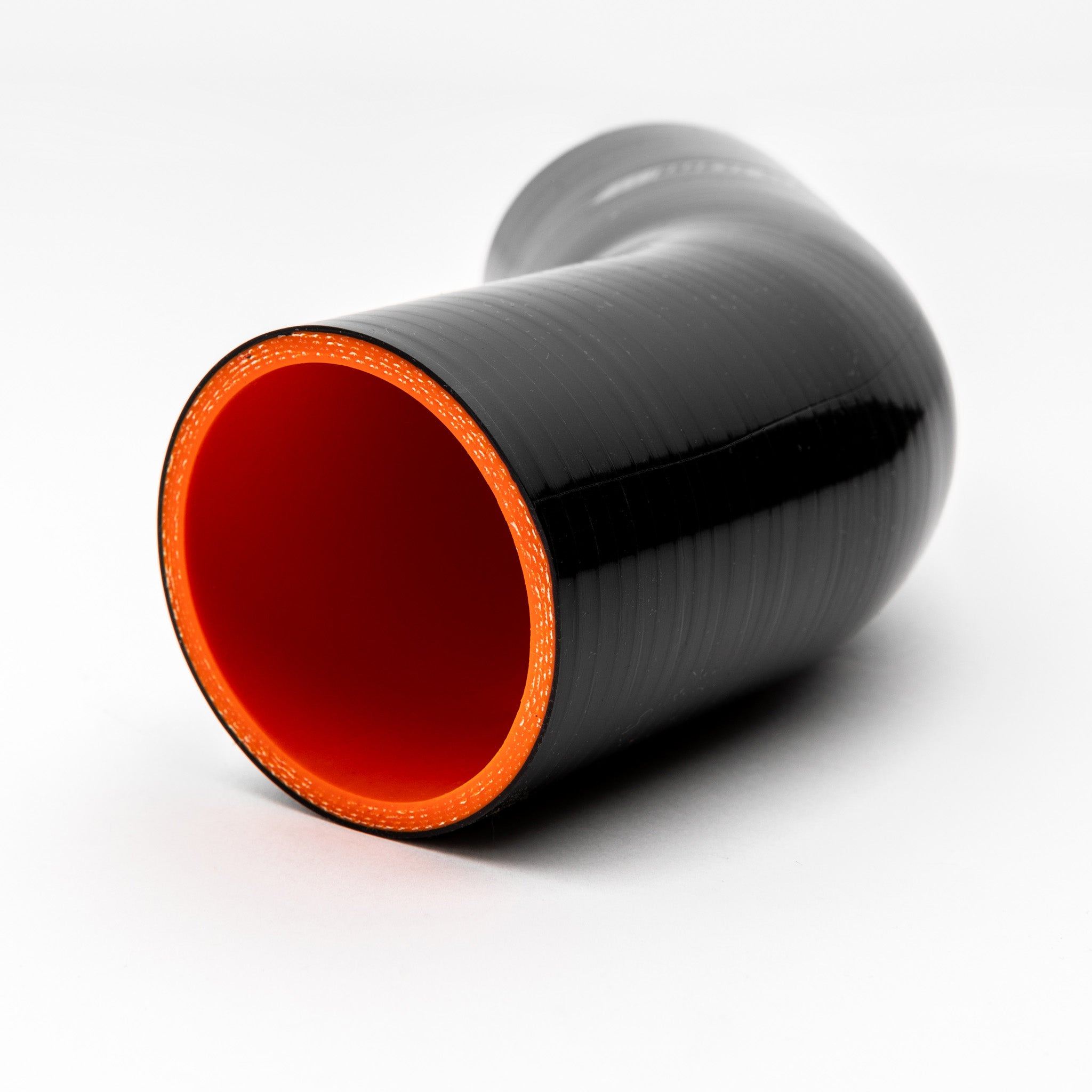 Black silicone hose with red interior on a white background