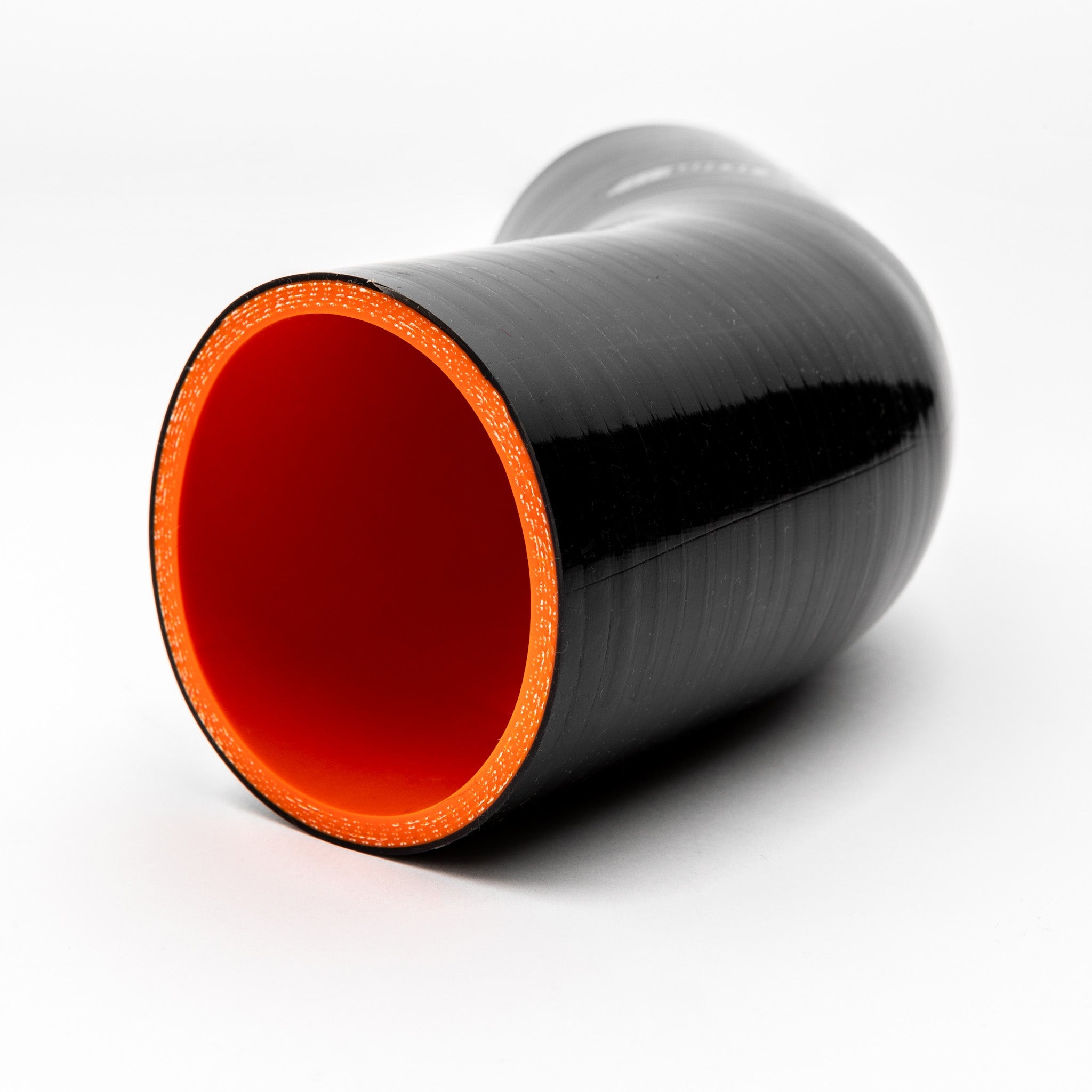 Black silicone hose with red interior on a white background