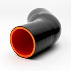 Black silicone reducer with red interior on a white background