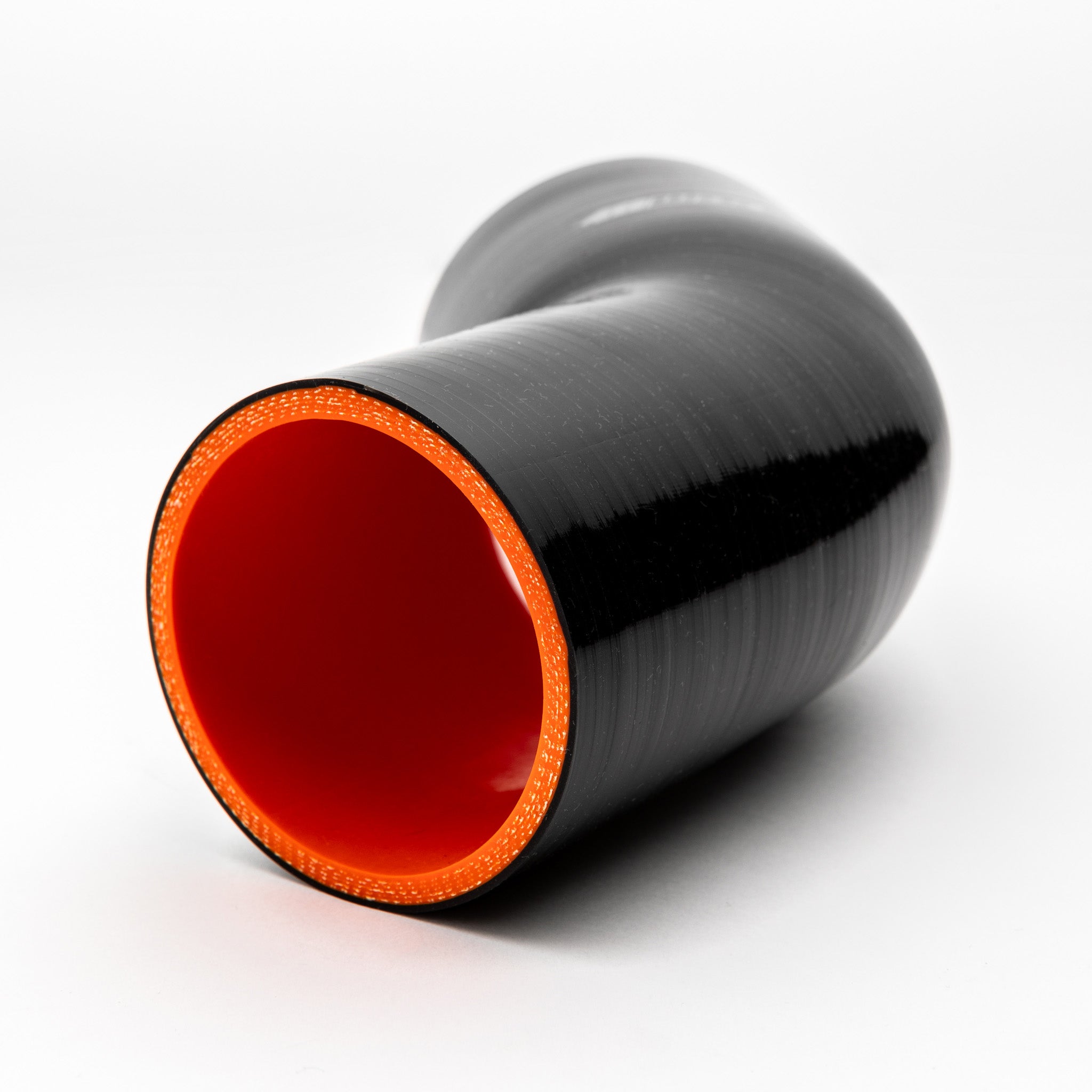 Black and red reducer fitting on a white background