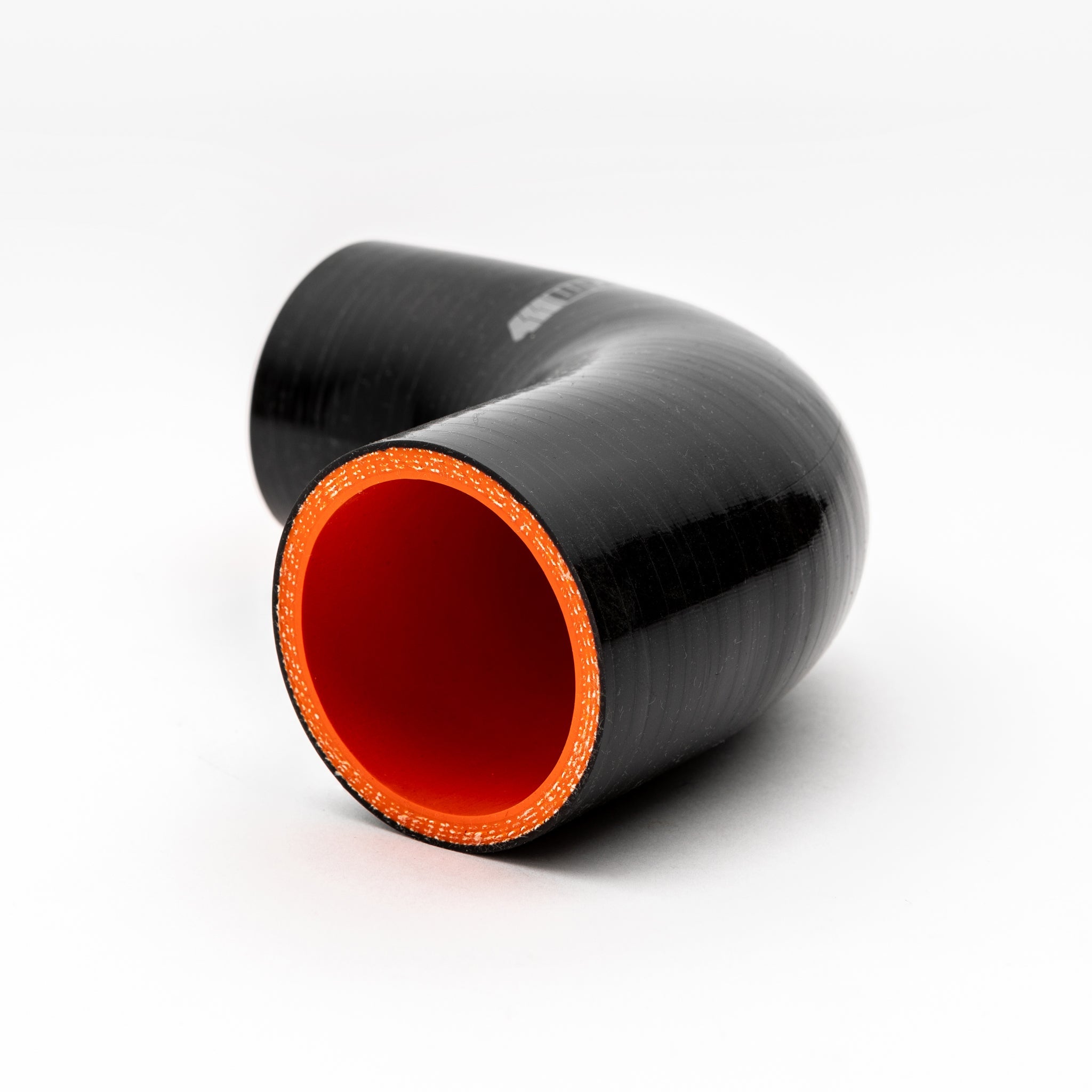 Black silicone hose with red interior on a white background