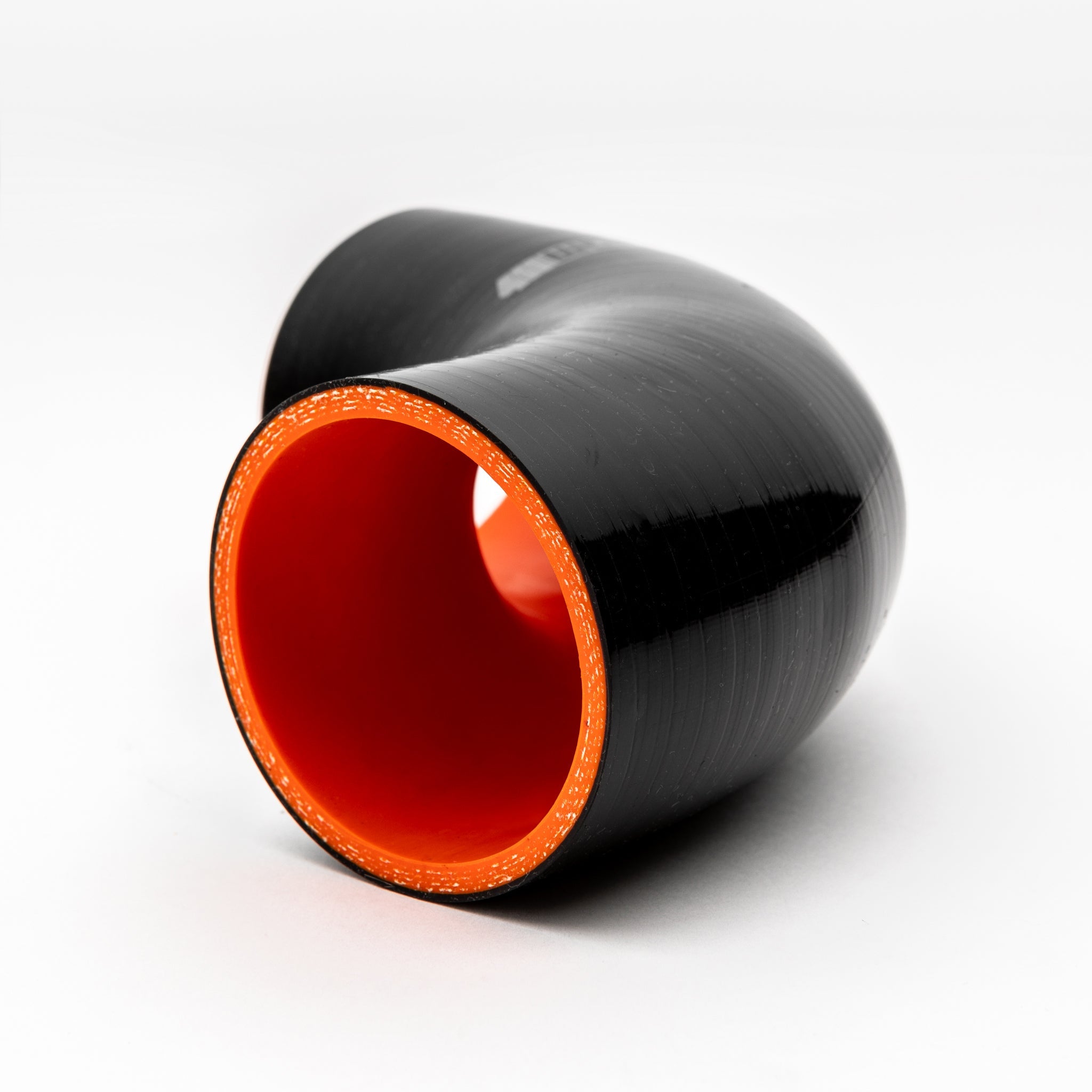 Black and red cylindrical object on a white background