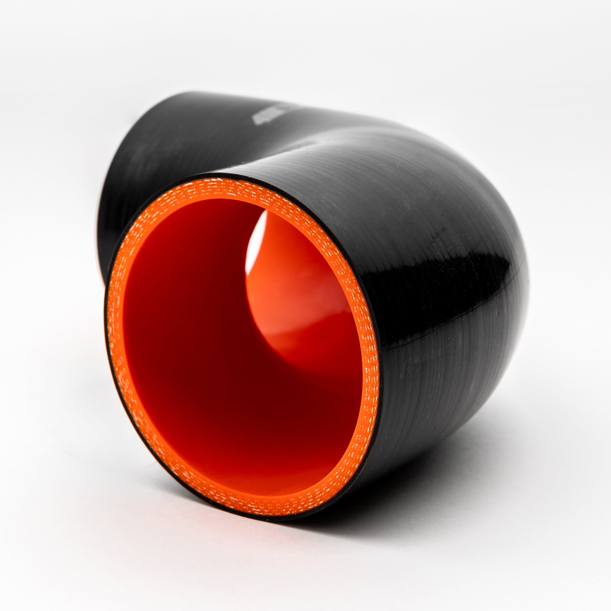Black cylindrical object with a red interior on a white background