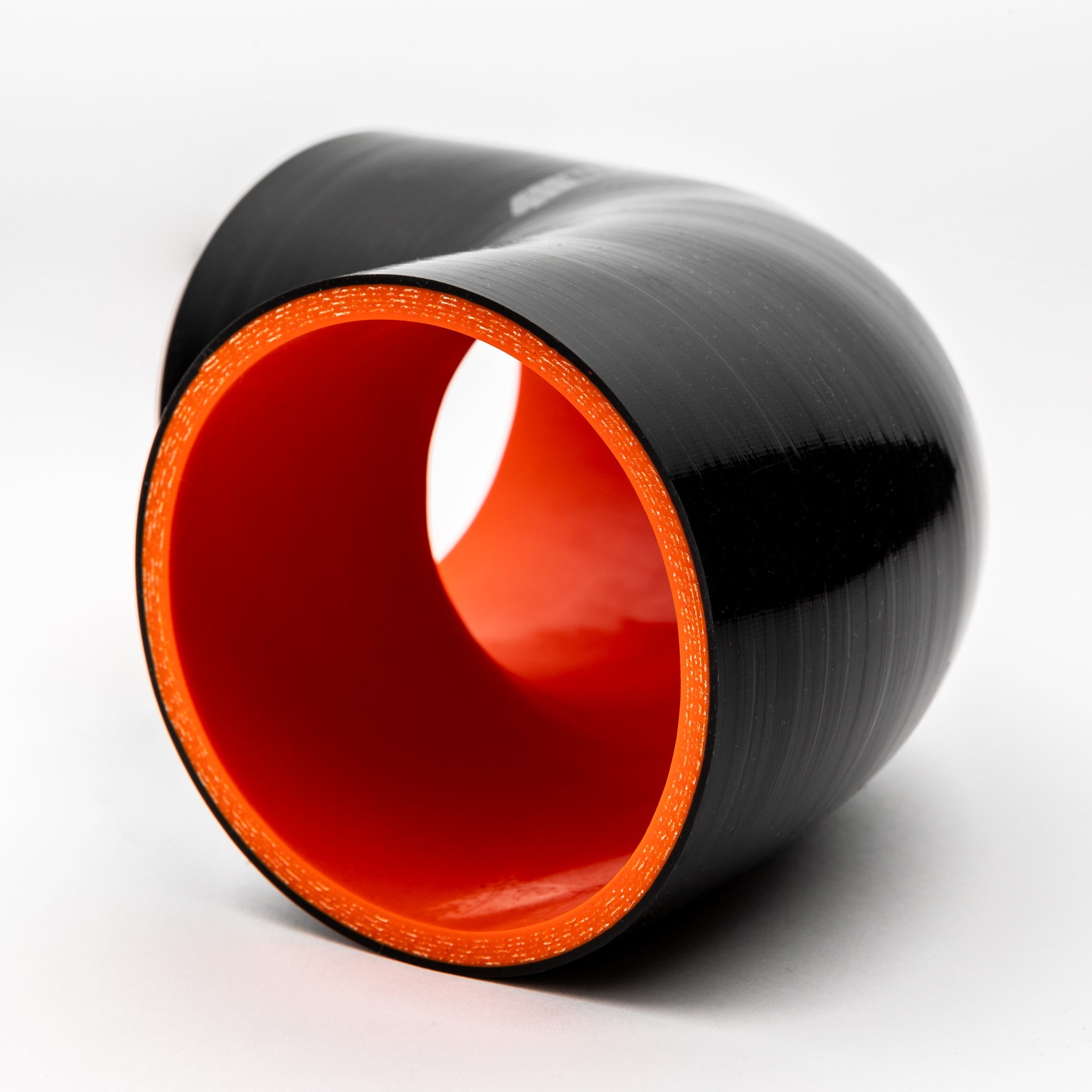 Black and red cylindrical object on a white background