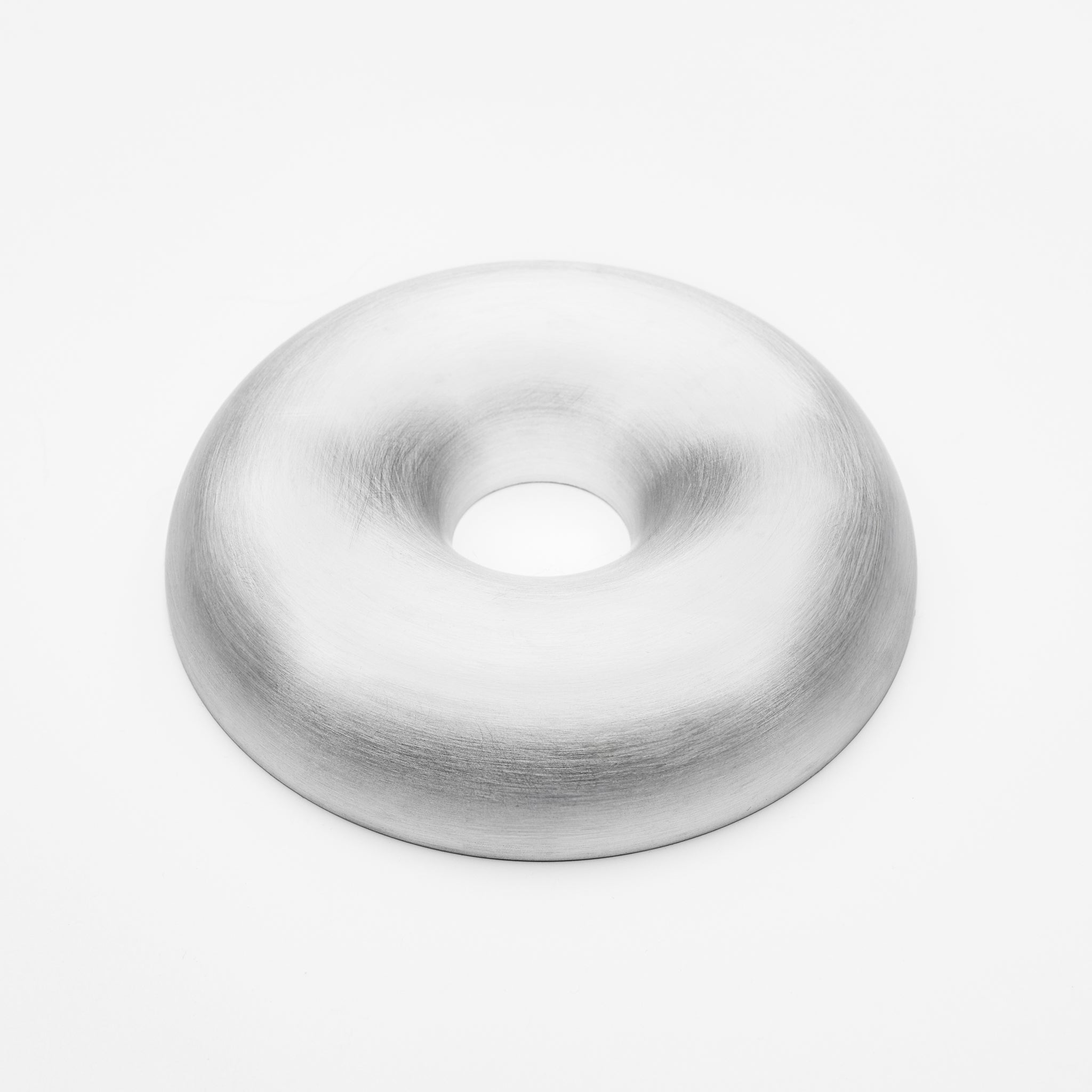Metallic donut-shaped object on a white background