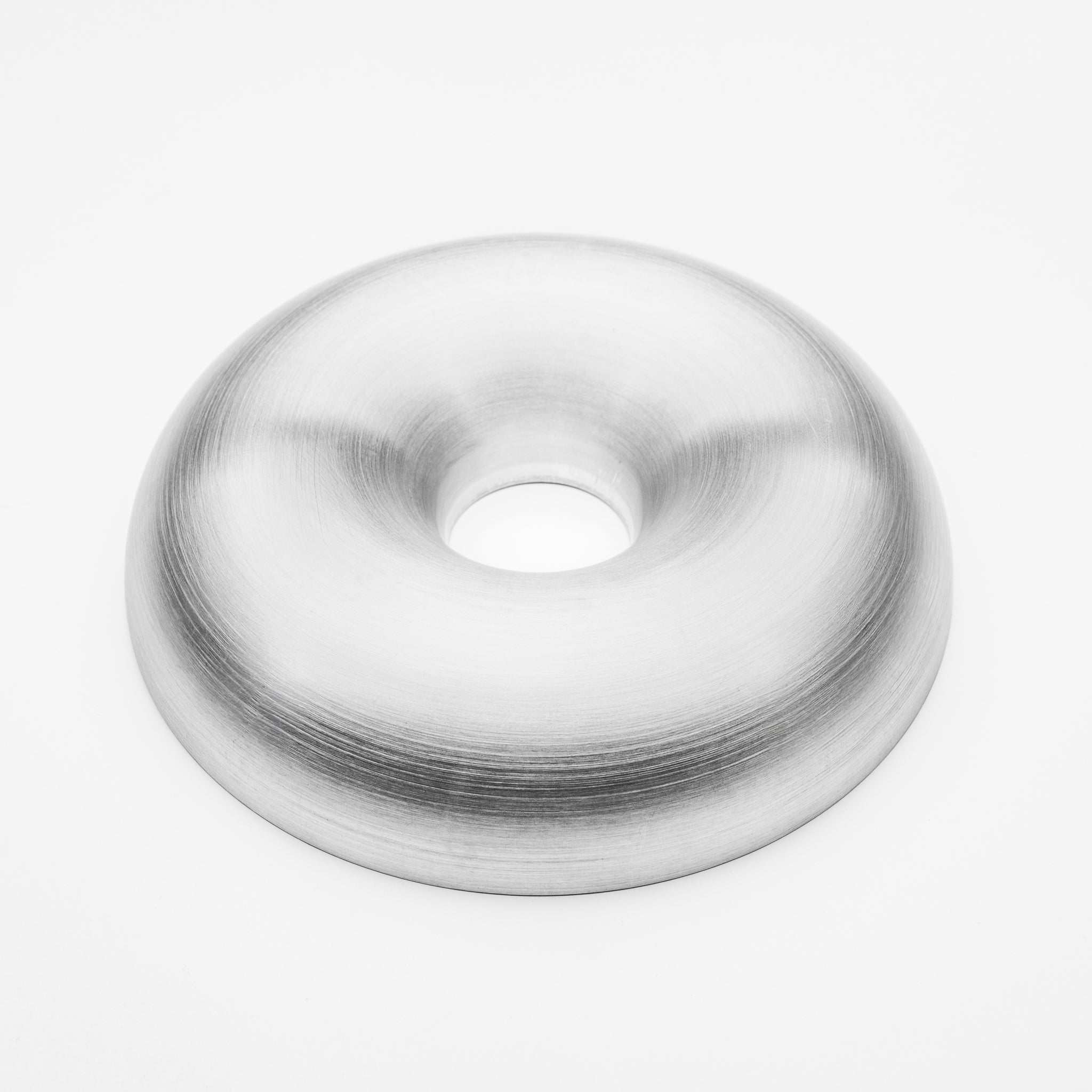 Metallic donut-shaped object on a white background