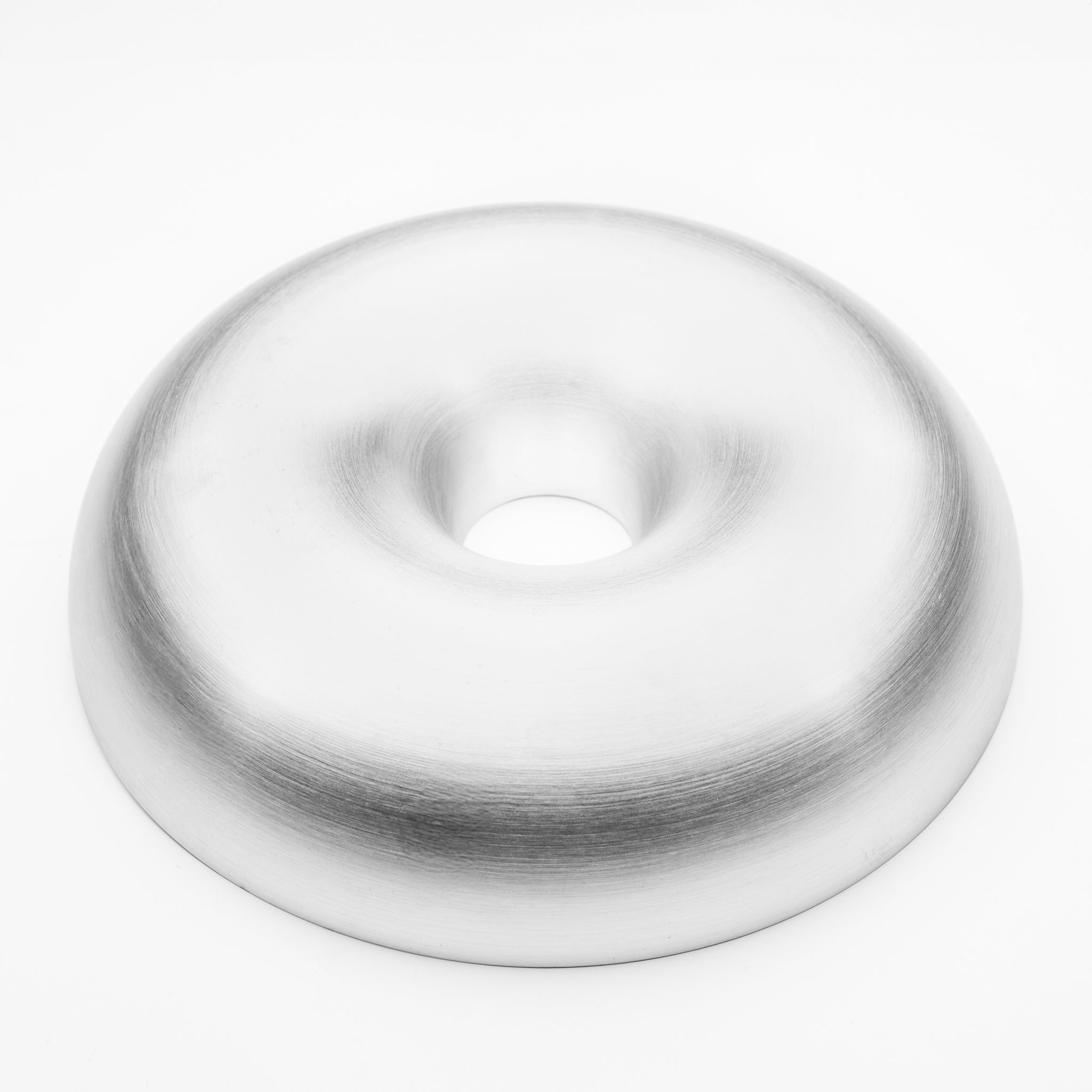 White aluminum welding donut-shaped object on a white background