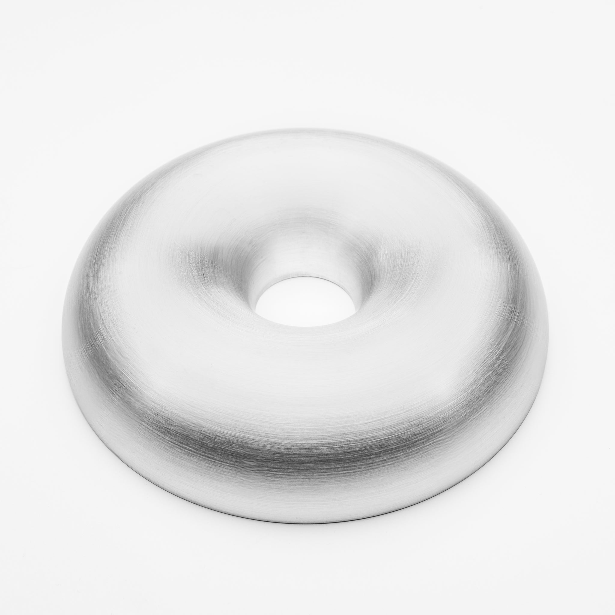 White aluminum donut-shaped object on a white background