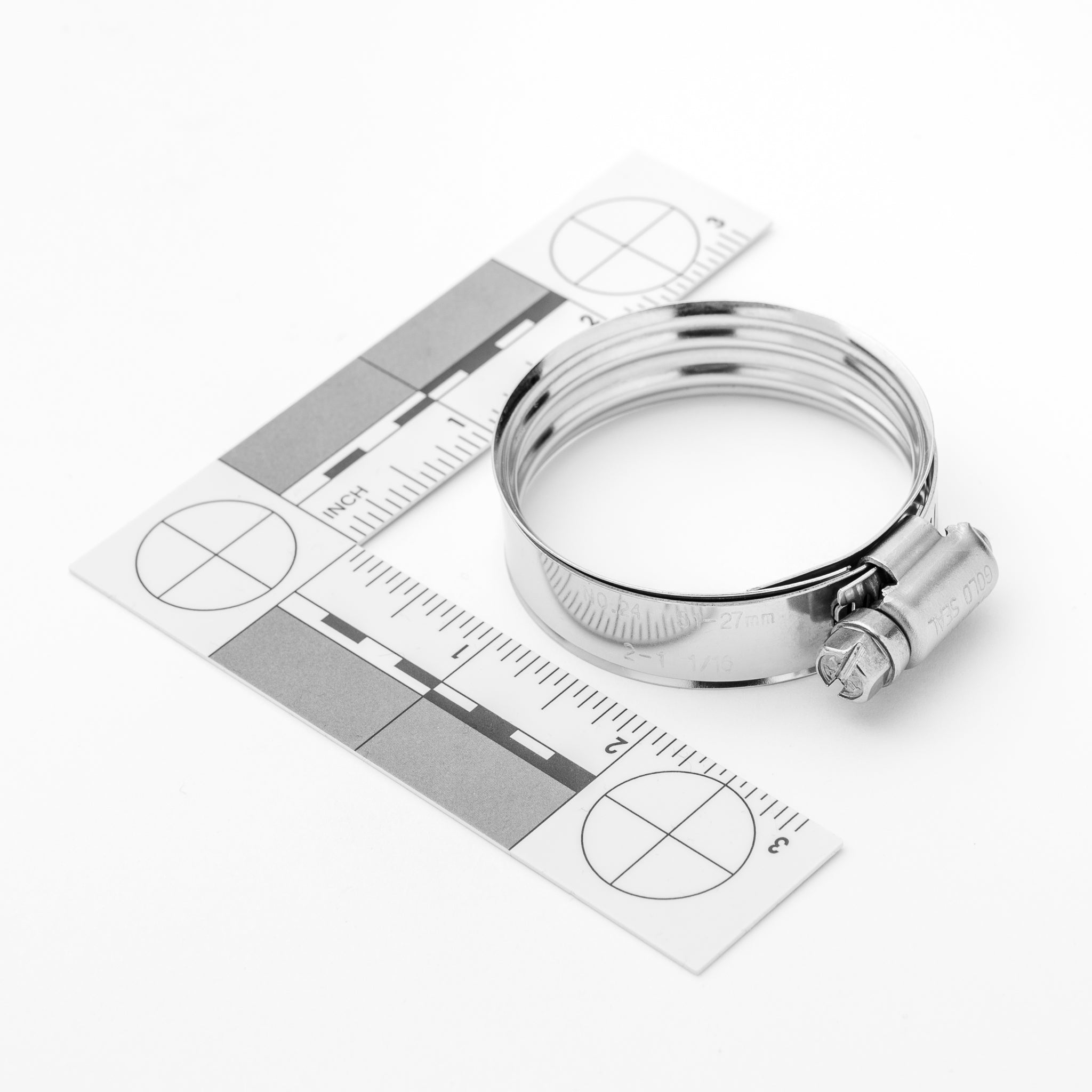 Metal hose clamp on a white background with measurement chart