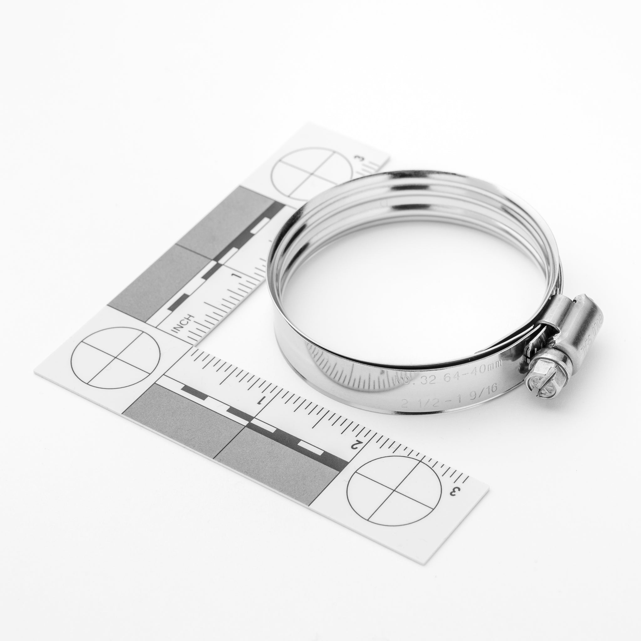 Metal hose clamp on a white background with measurement chart