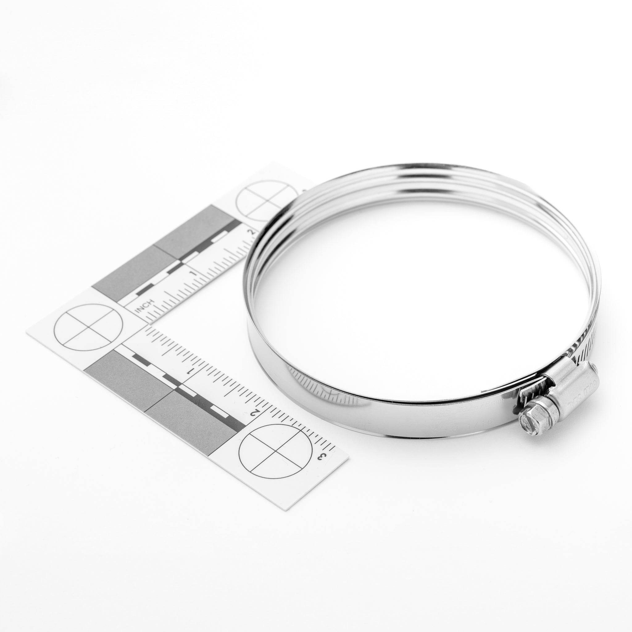 Silver measuring clamp with ruler on a white background