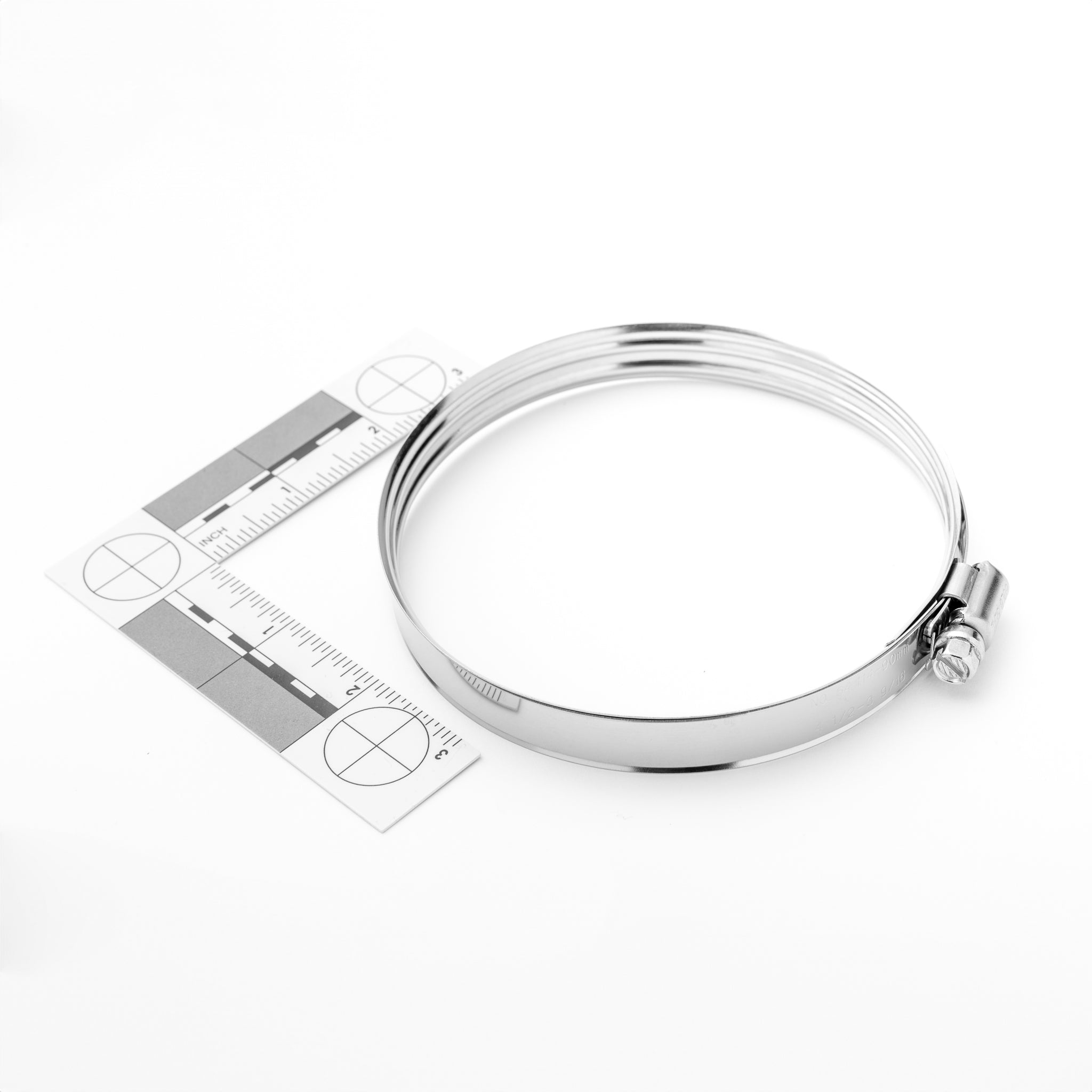 Silver clamp with a ruler for size reference on a white background