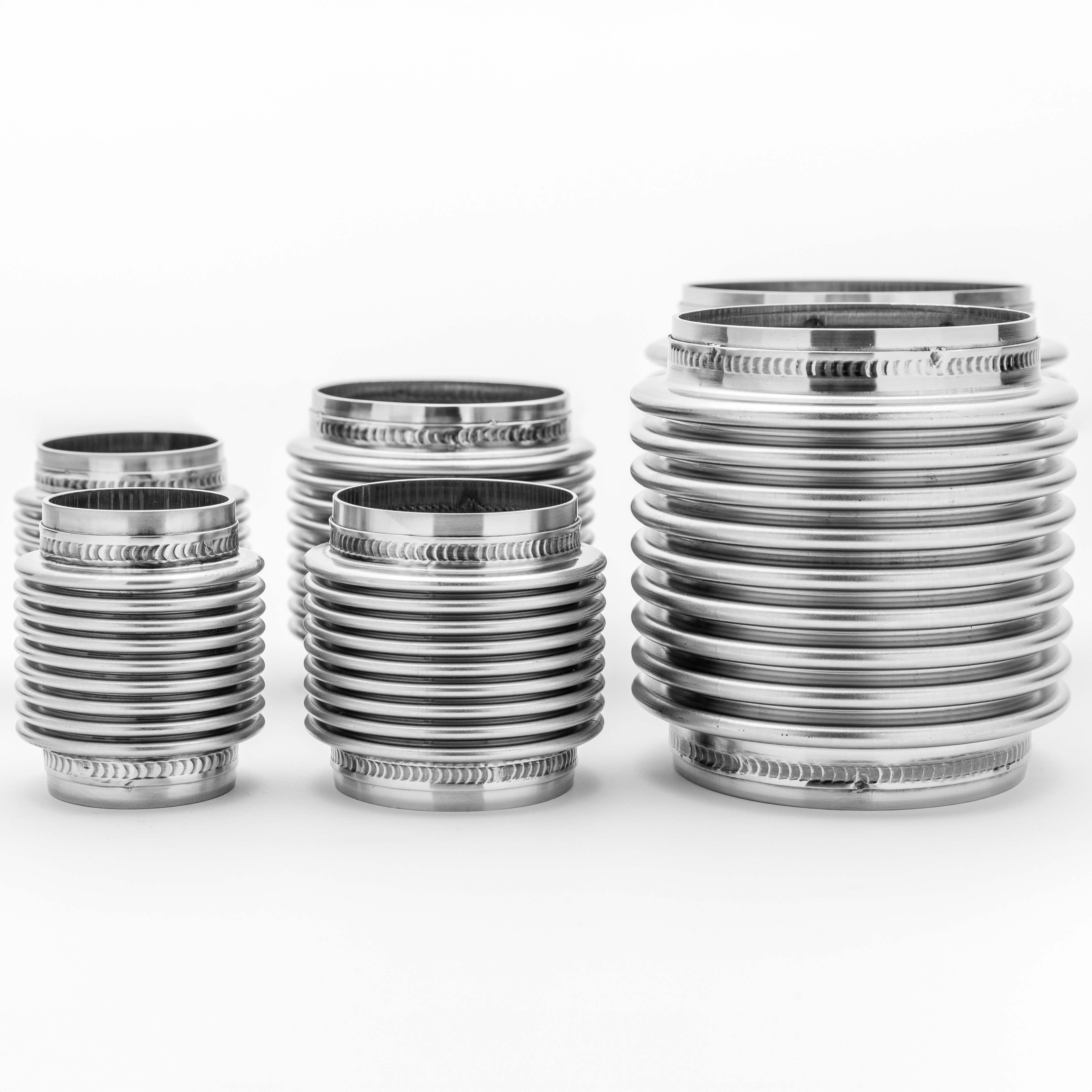 Set of metallic bellow joint objects on a white background