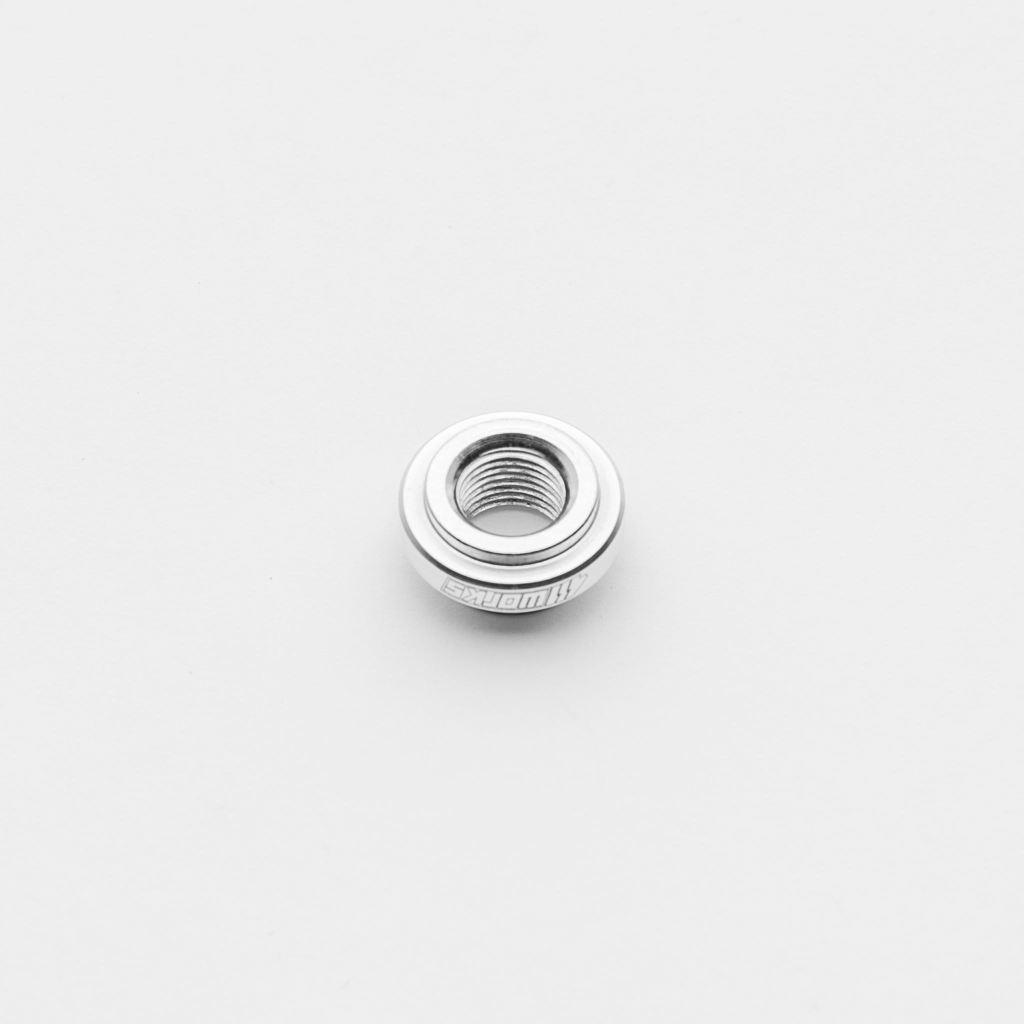 Metallic bung on a light gray background