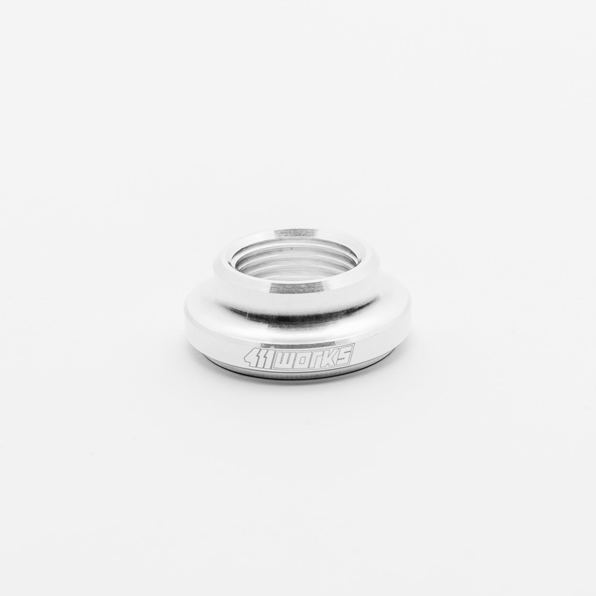 Silver metal bushing with '411 WORKS' branding on a white background