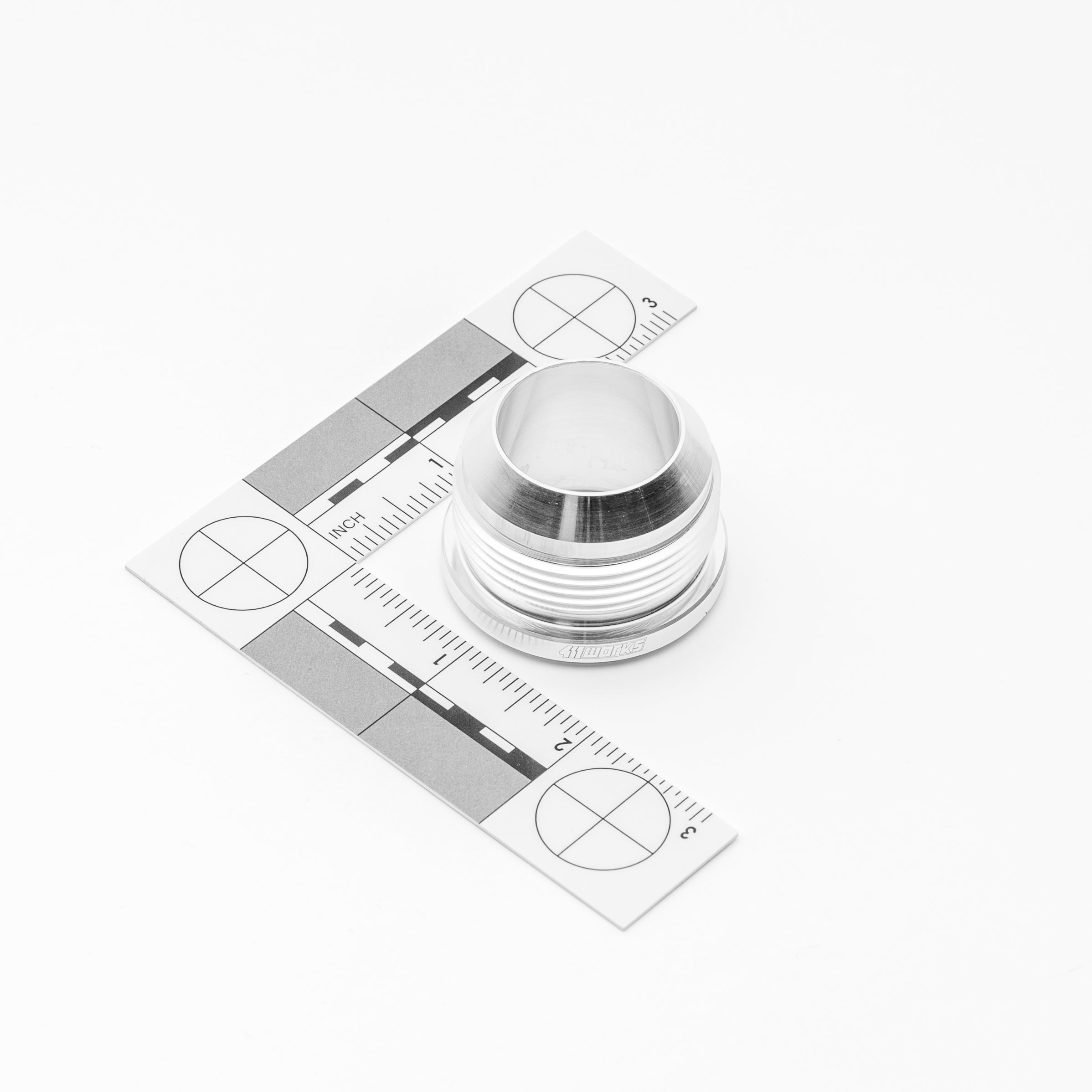 Metallic AN fitting with a detailed label on a white background