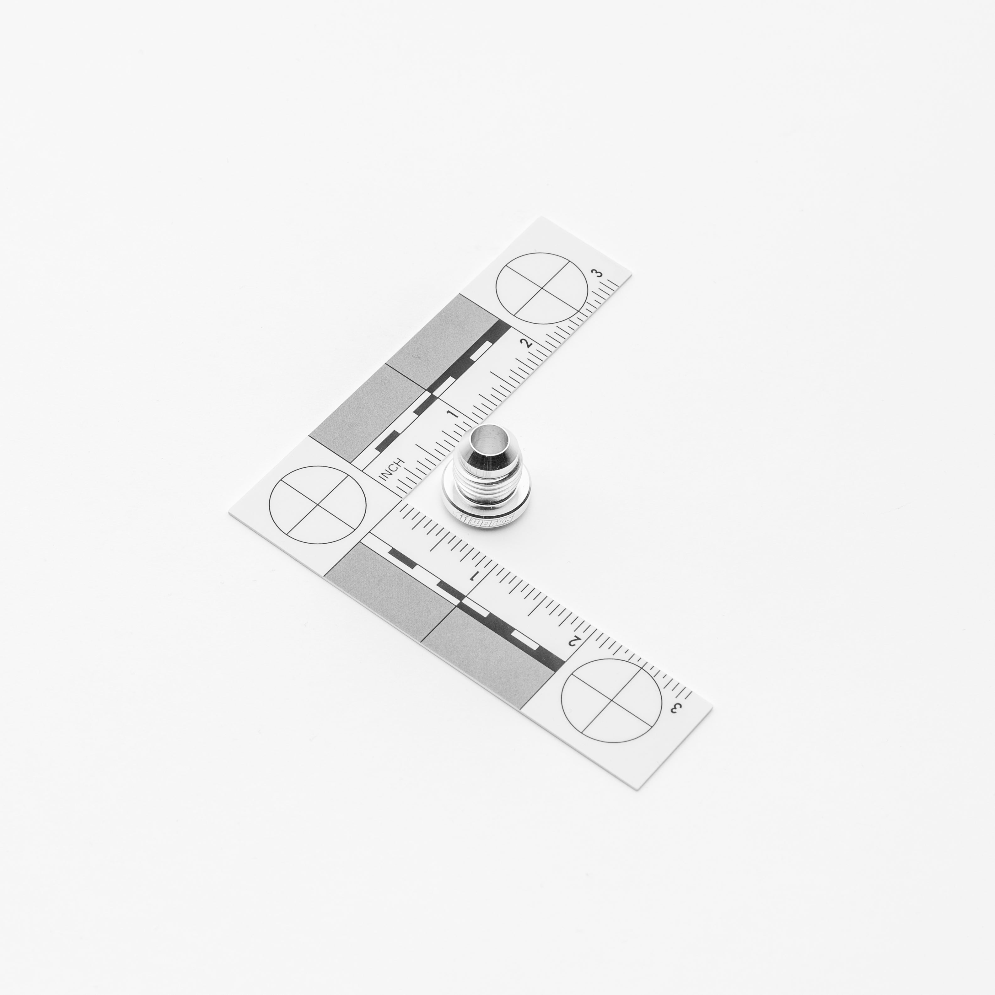 An fitting with ruler and weight on a white background