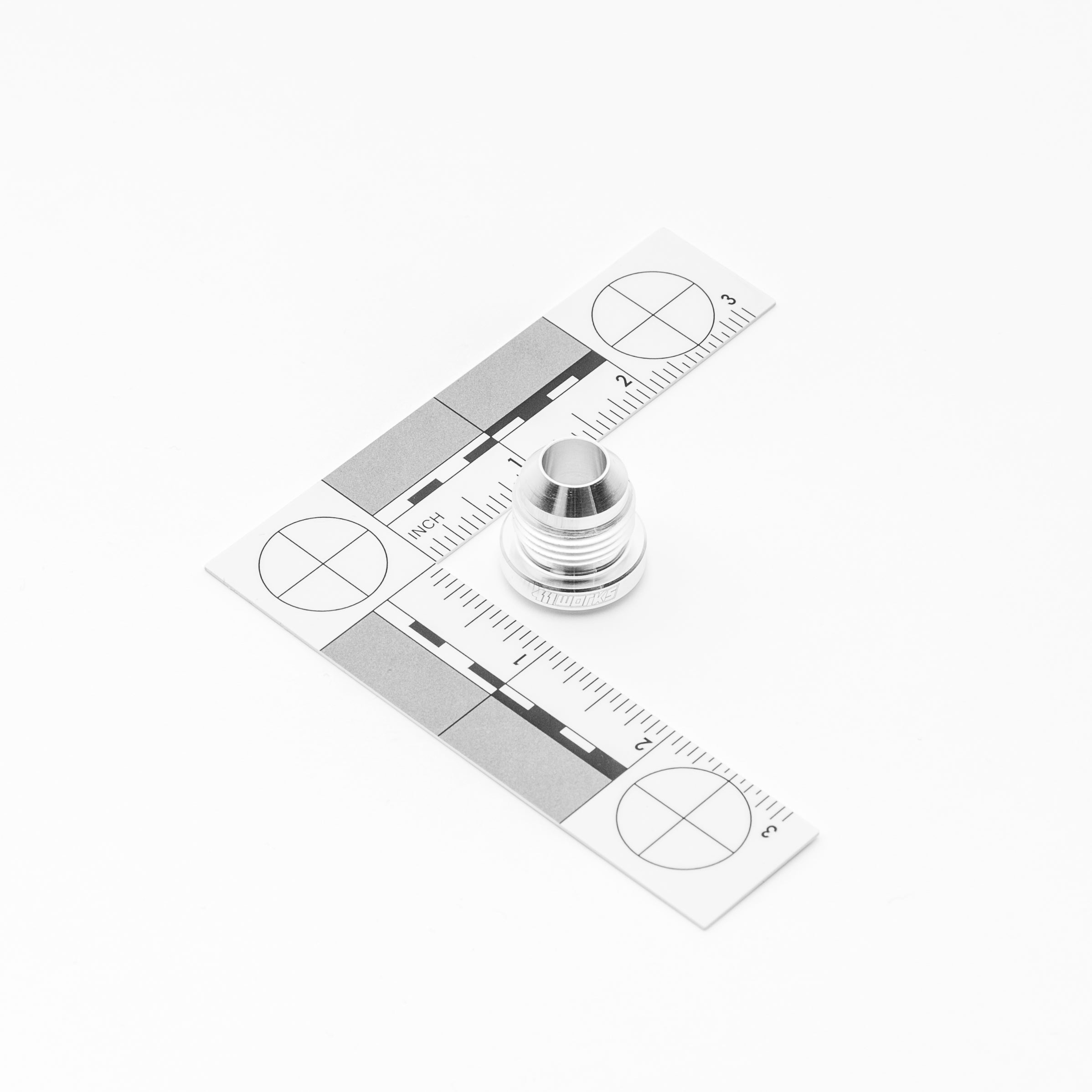 Metal AN fitting with a ruler on a white background