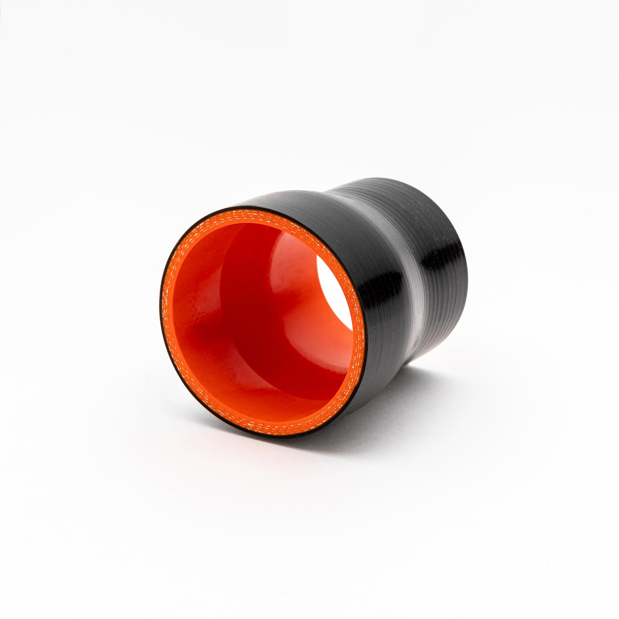 Black and red cylindrical coupler on a white background