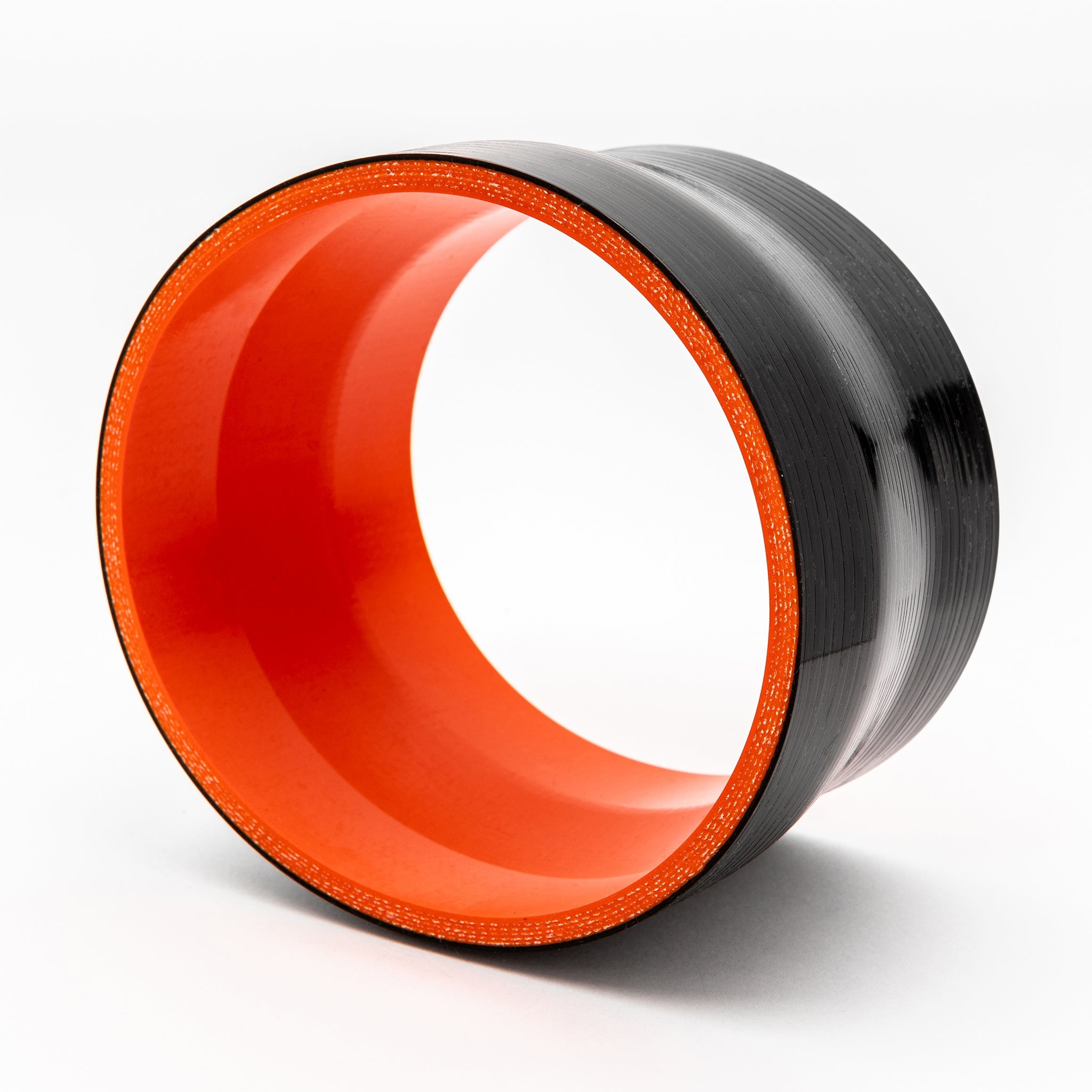Circular object with orange interior and black exterior on a white background