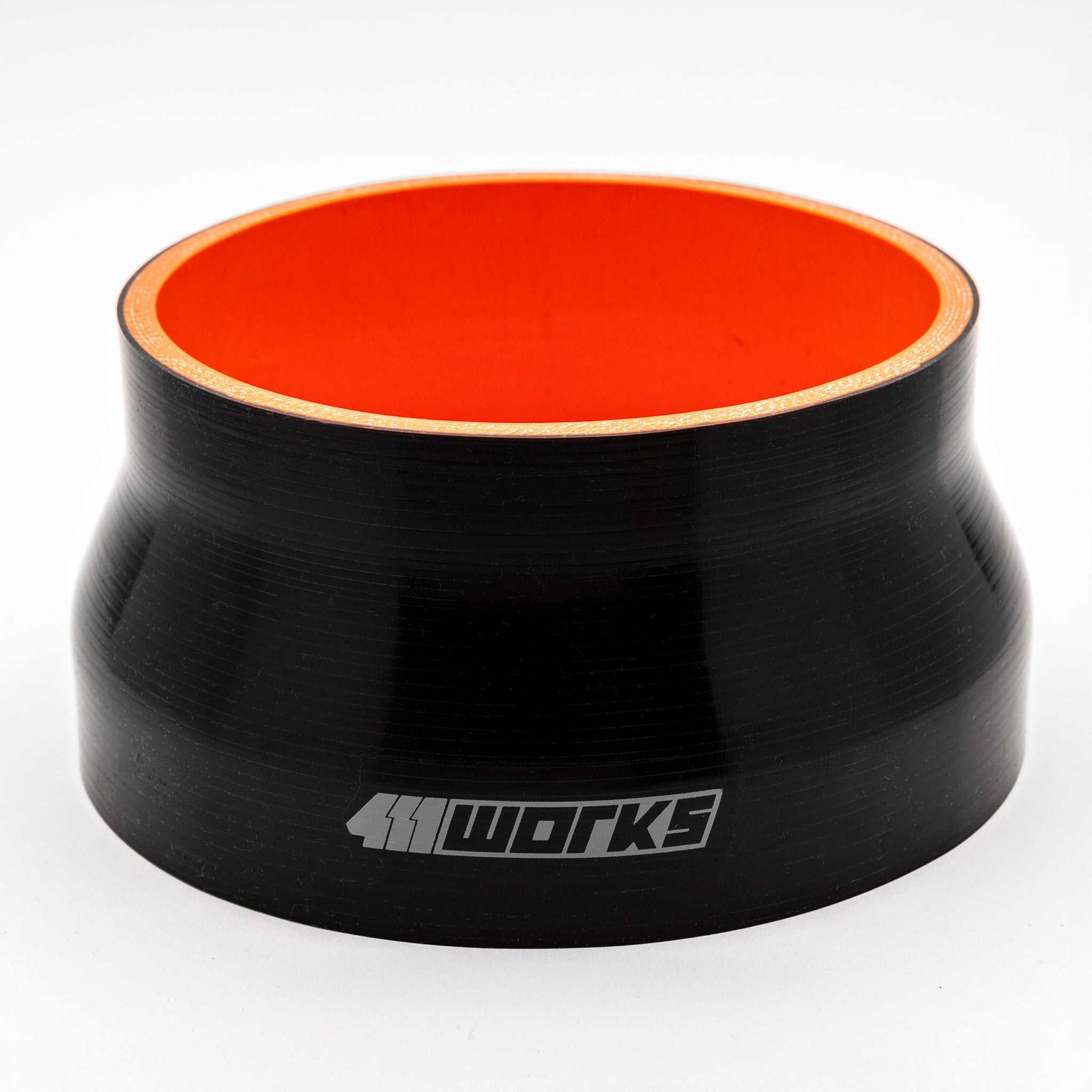 Black silicone hose with orange interior on a white background