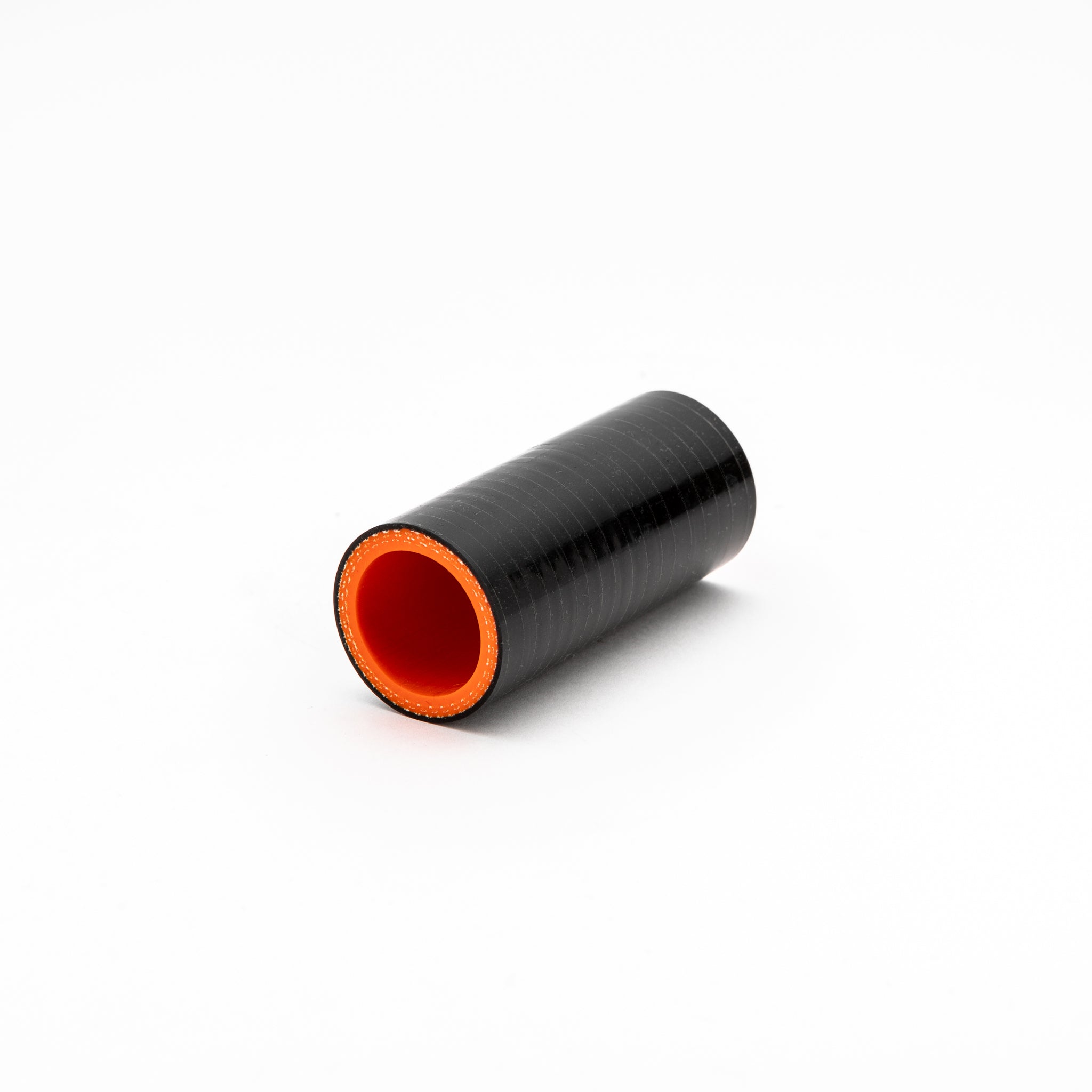Black silicone hose with orange interior on a white background