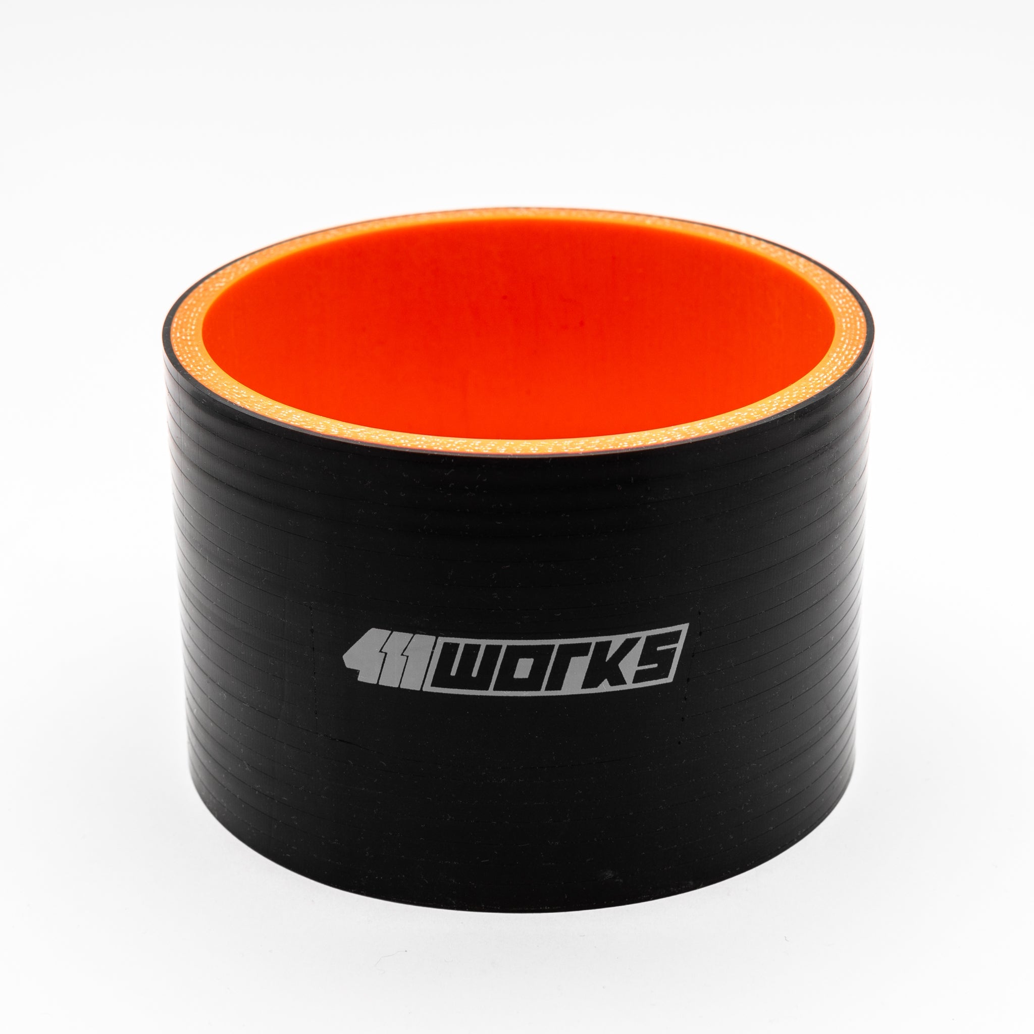 Black silicone hose with orange interior on a white background