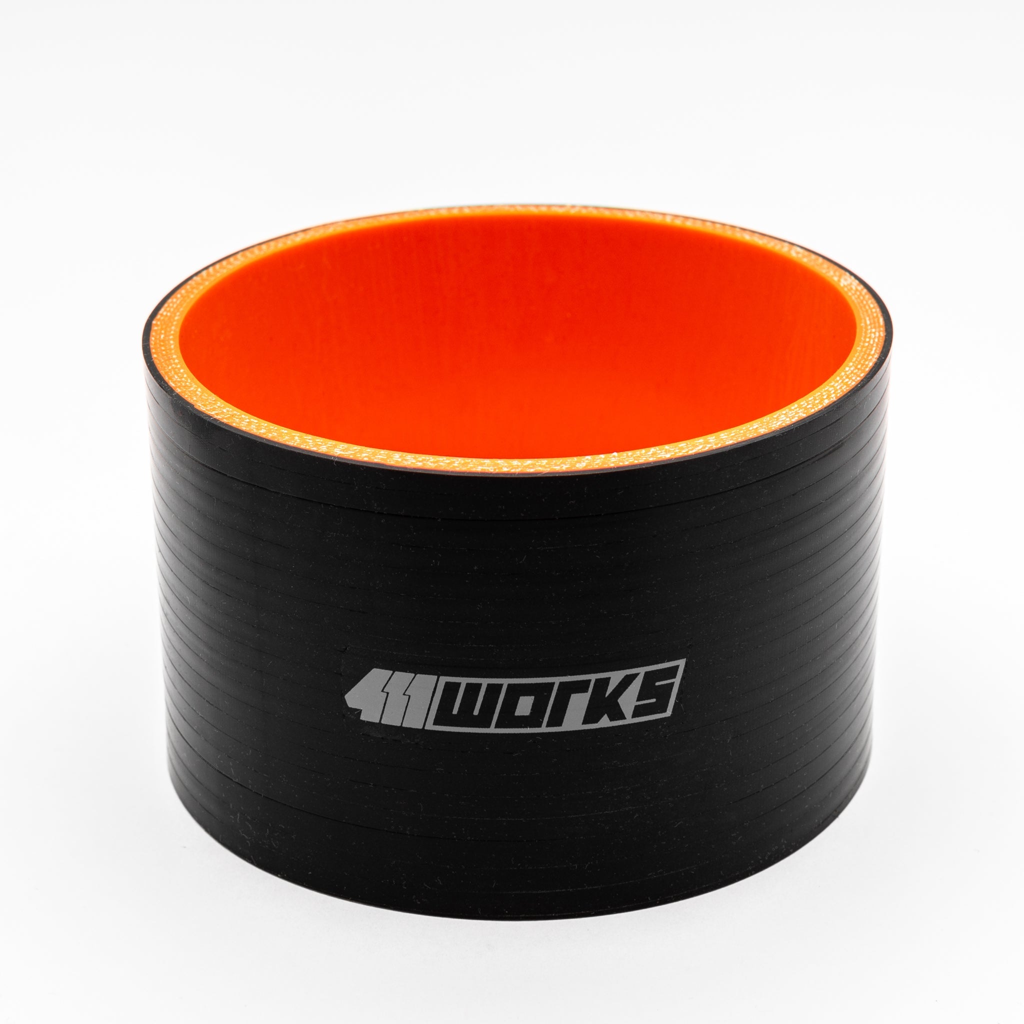 Black silicone hose with orange interior on a white background