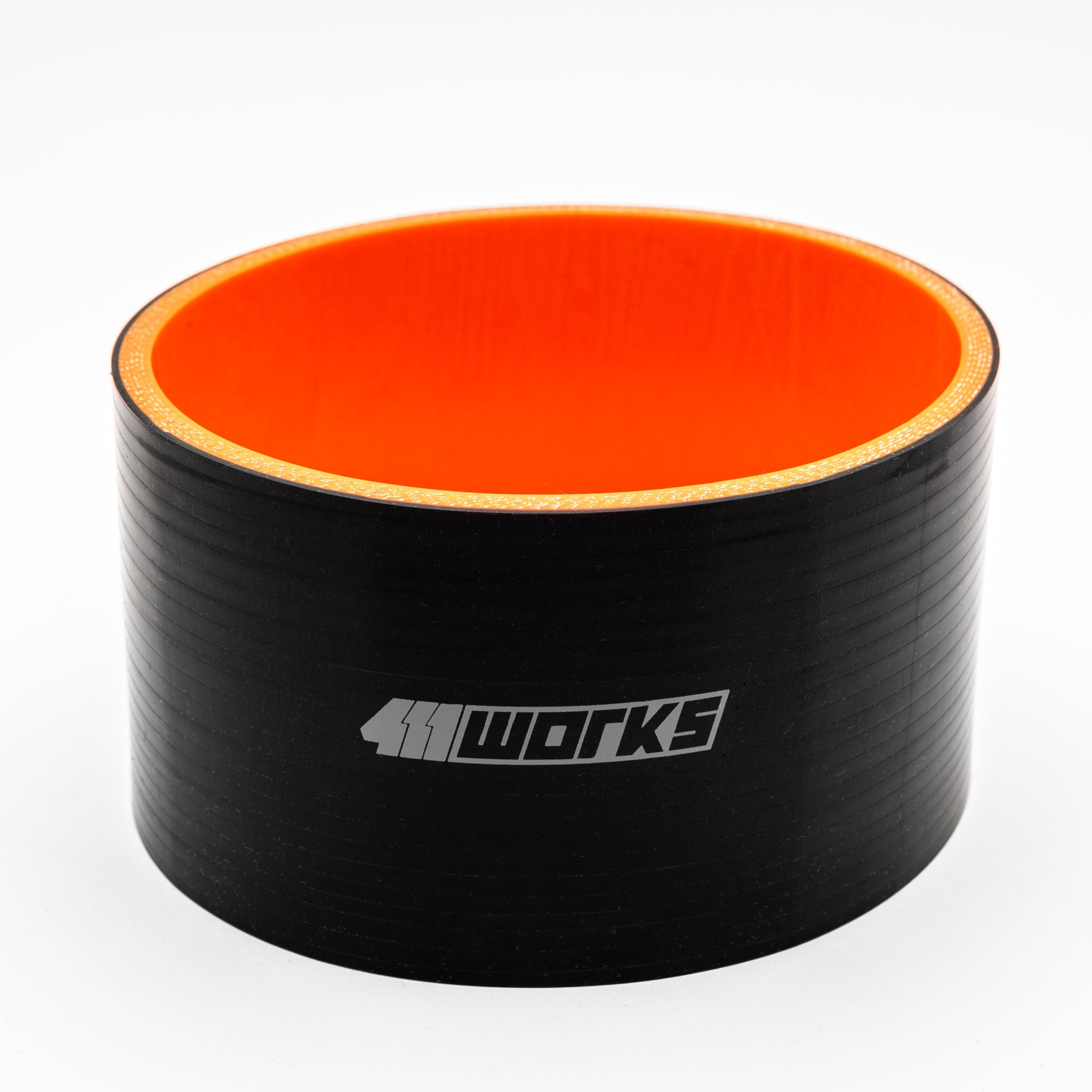 Black silicone hose with orange interior on a white background