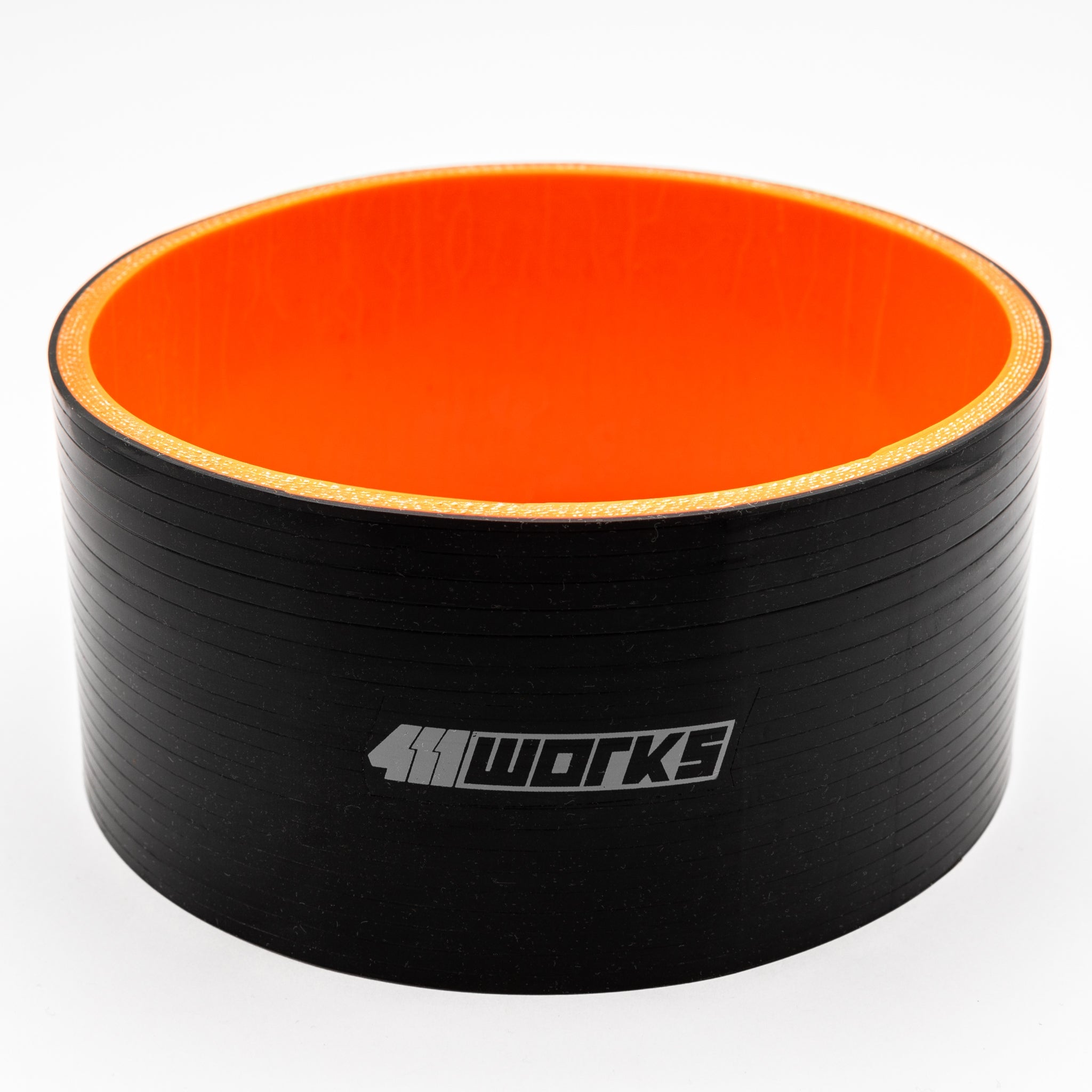 Black and orange cylindrical object with '411 Works' branding on a white background