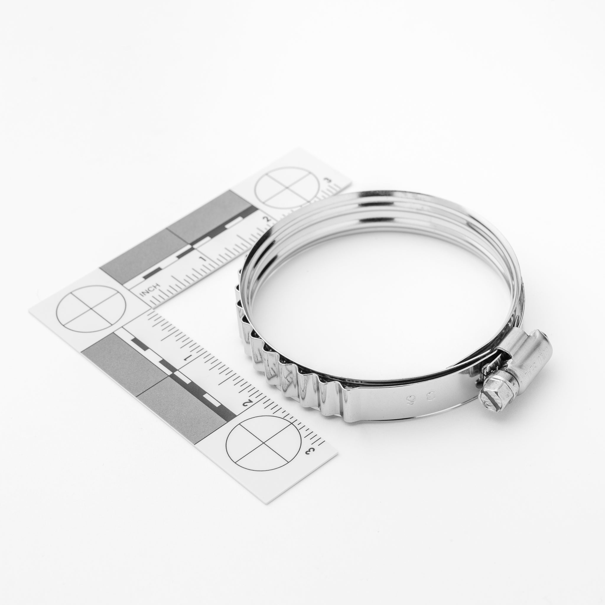 Metal clamp with a ruler on a white background