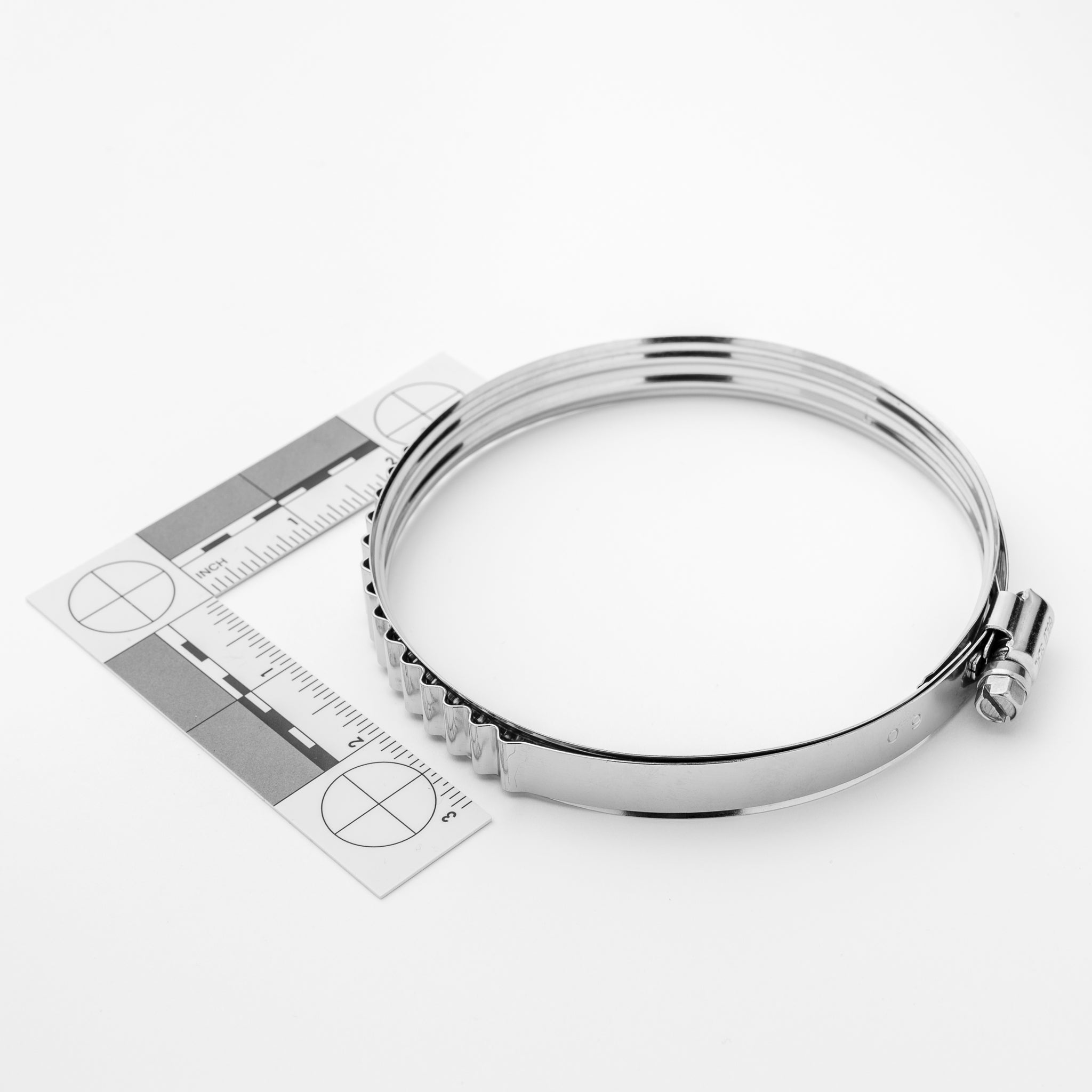 Metallic clamp with a ruler on a white background