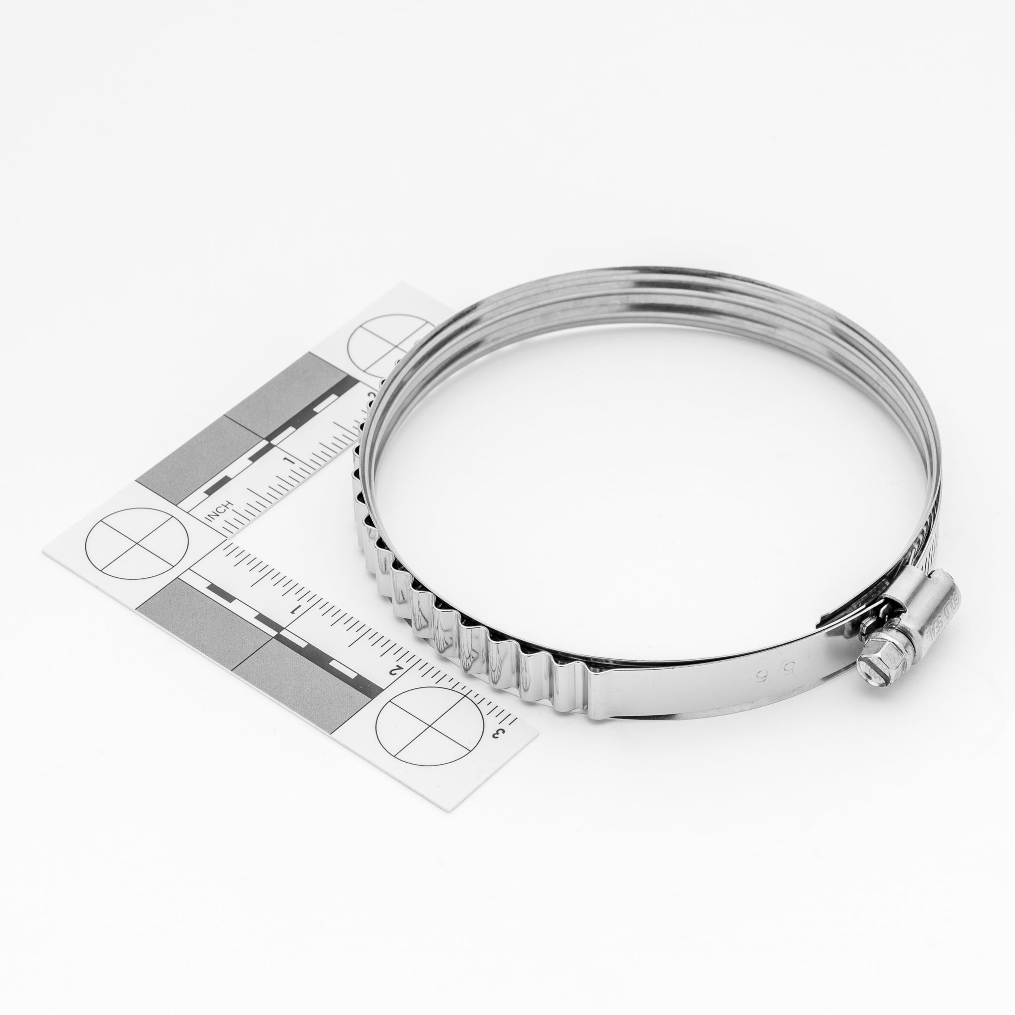 Silver adjustable clamp with a ruler on a white background