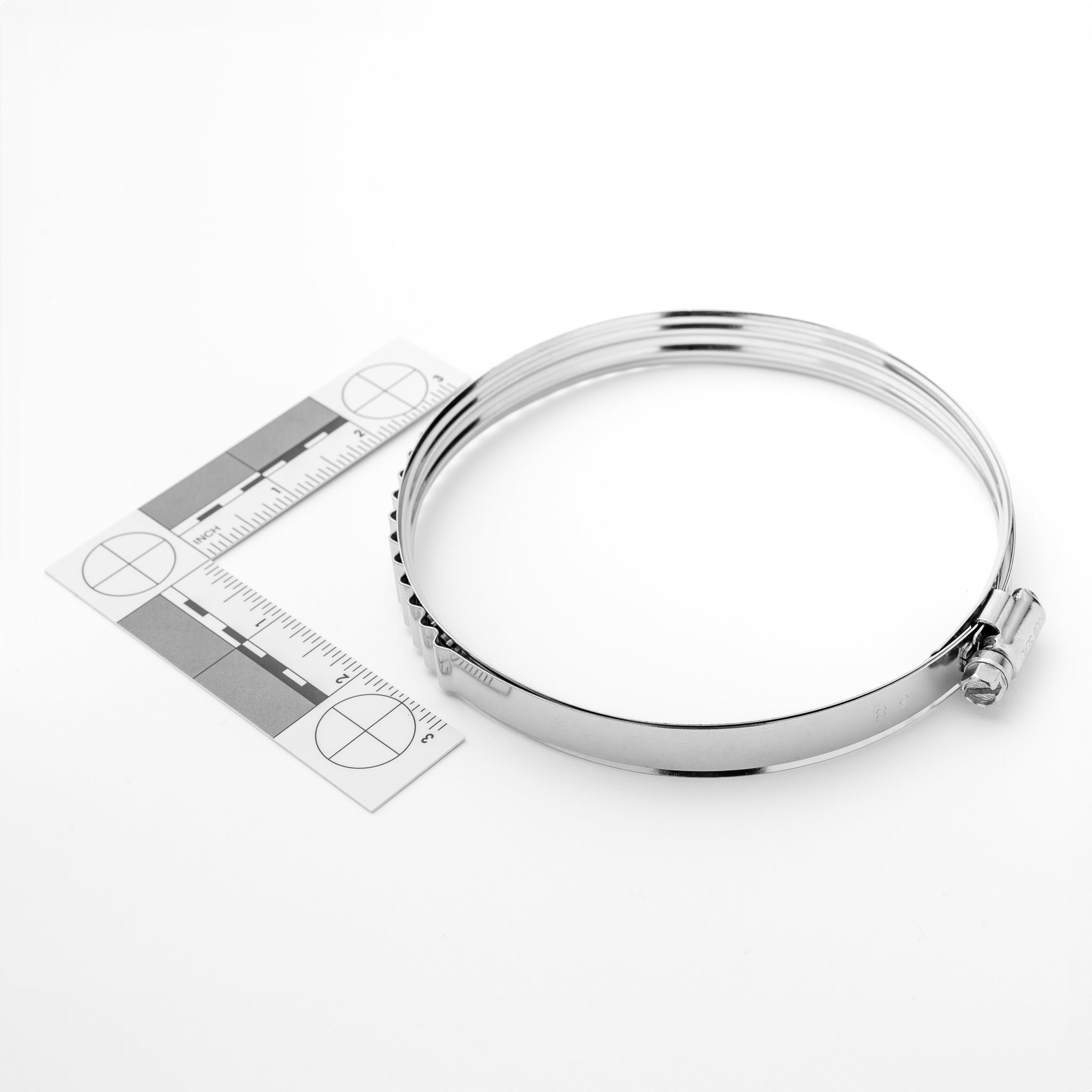 Metal clamp with a ruler on a white background