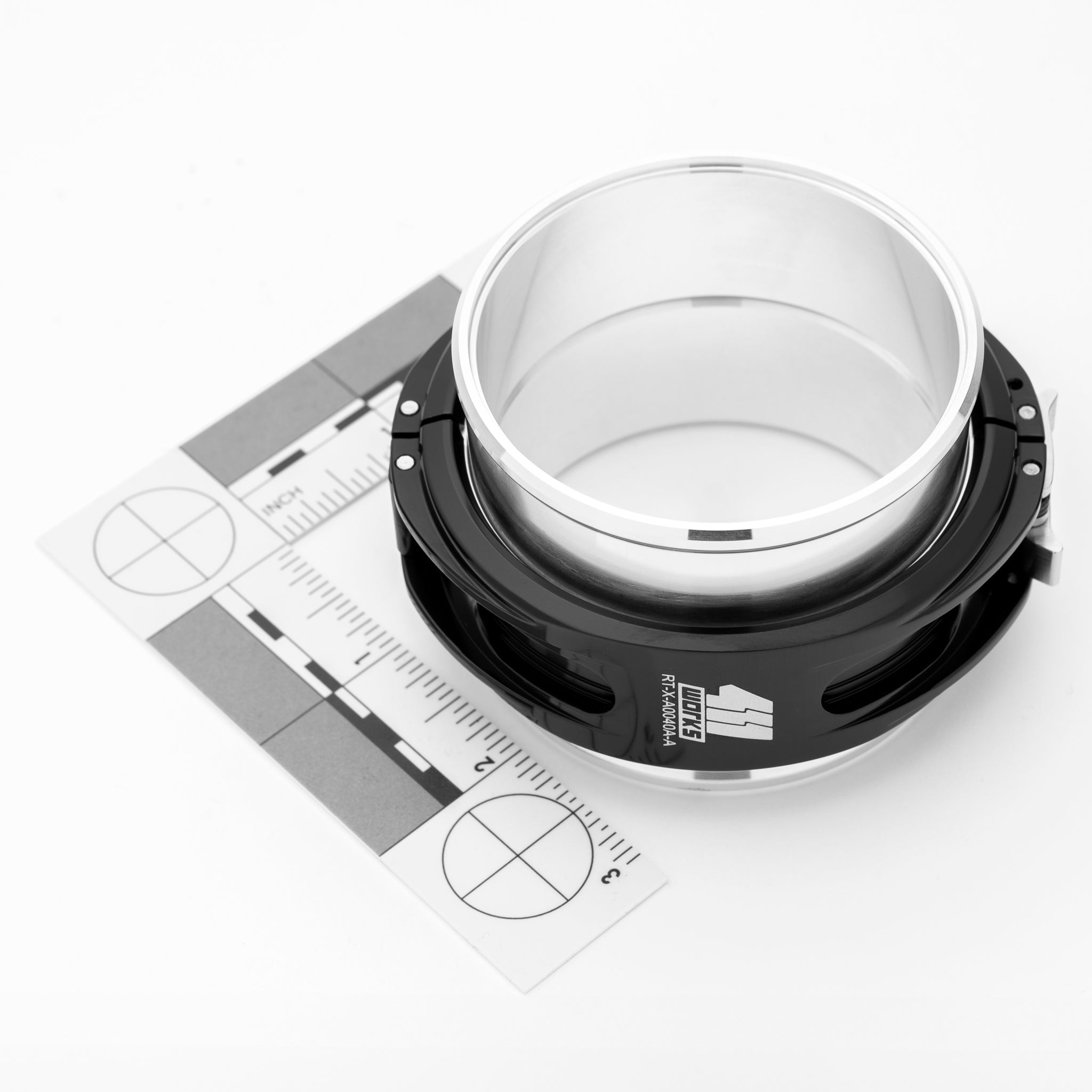 Black and white mechanical component on a white background with measurement scale