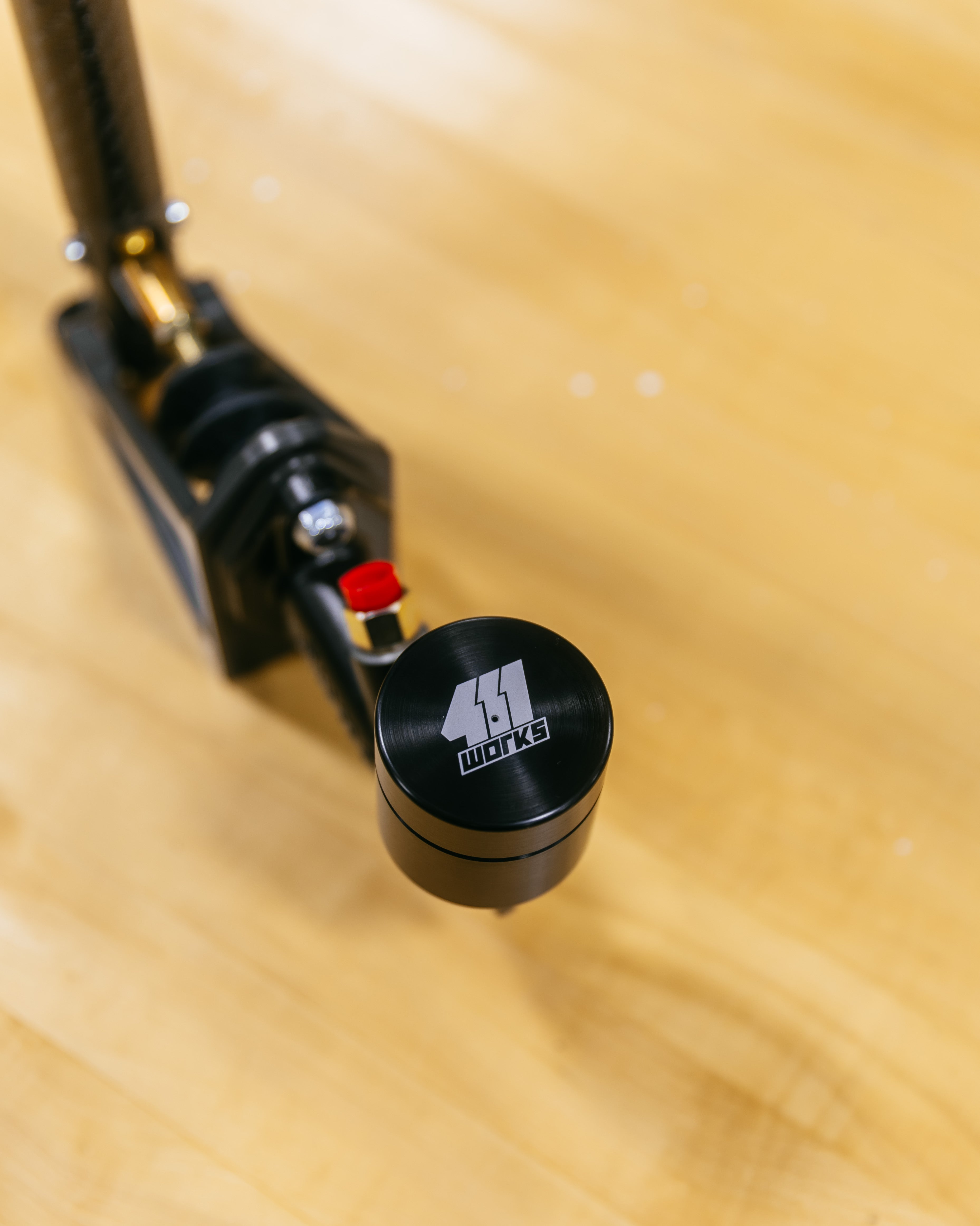 Close-up of a black and red reservoir on a wooden surface