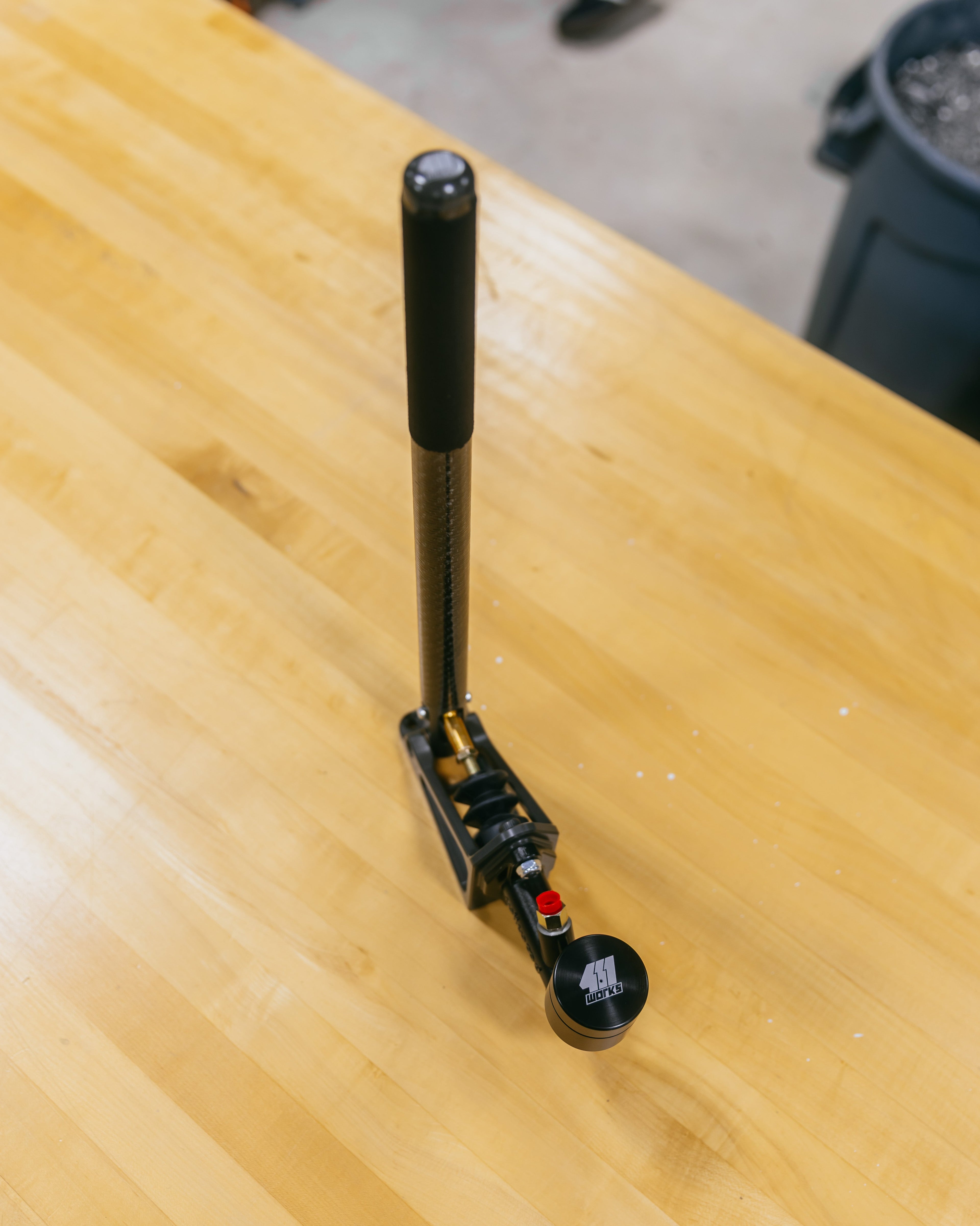 Black and silver handbrake on a wooden table