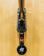 Close-up of a hydraulic handbrake on a wooden surface