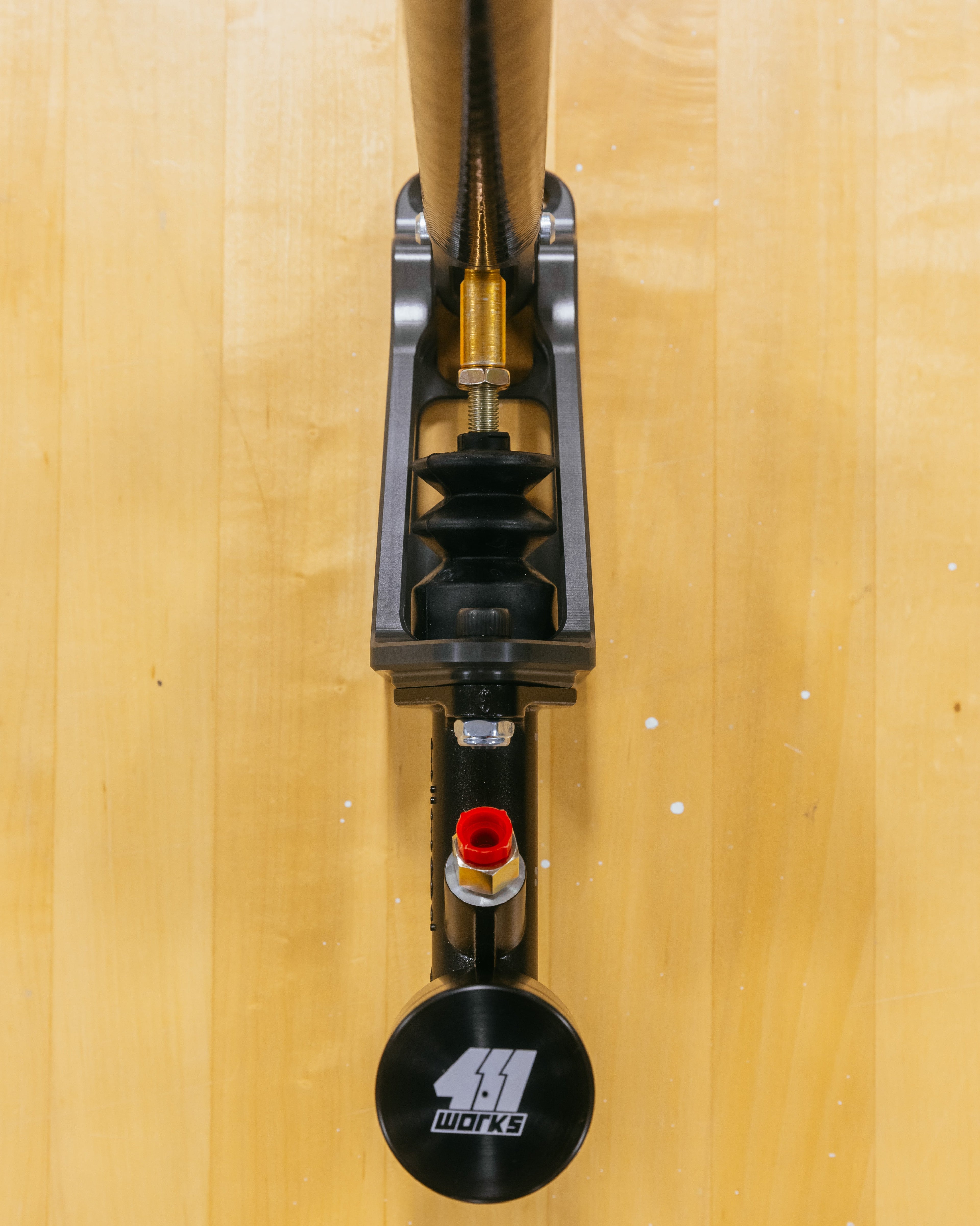 Close-up of a hydraulic handbrake on a wooden surface