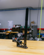 Black handbrake on a table with a blurred workshop background