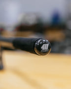 Close-up of a black handbrake with a logo on a blurred background