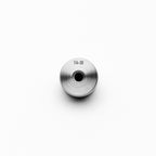 Metallic steel weld bung with threading on a white background