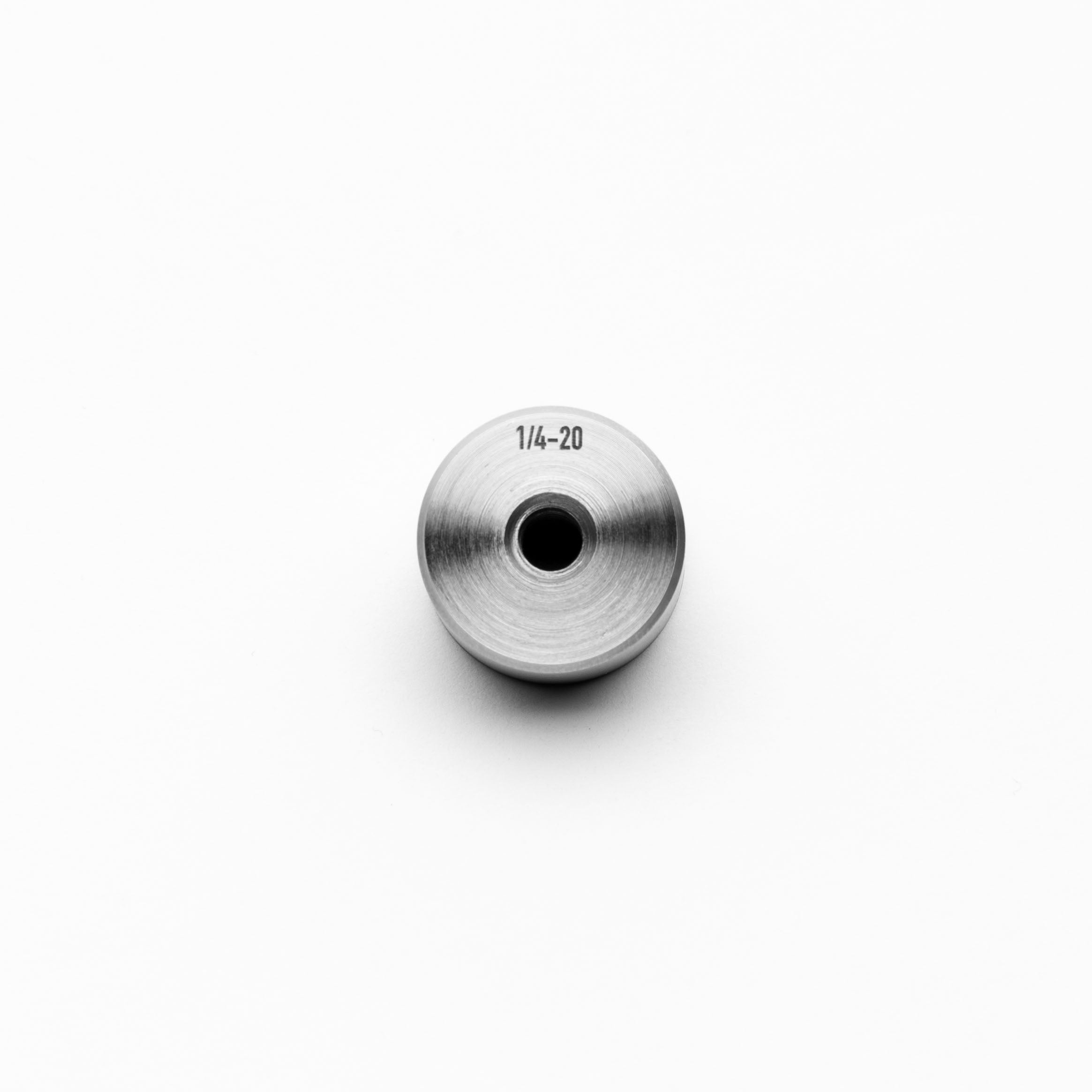 Metallic steel weld bung with threading on a white background