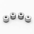 Four coped weld bungs with different thread sizes on a white background