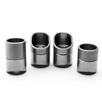 Set of four metallic coped weld bungs on a white background