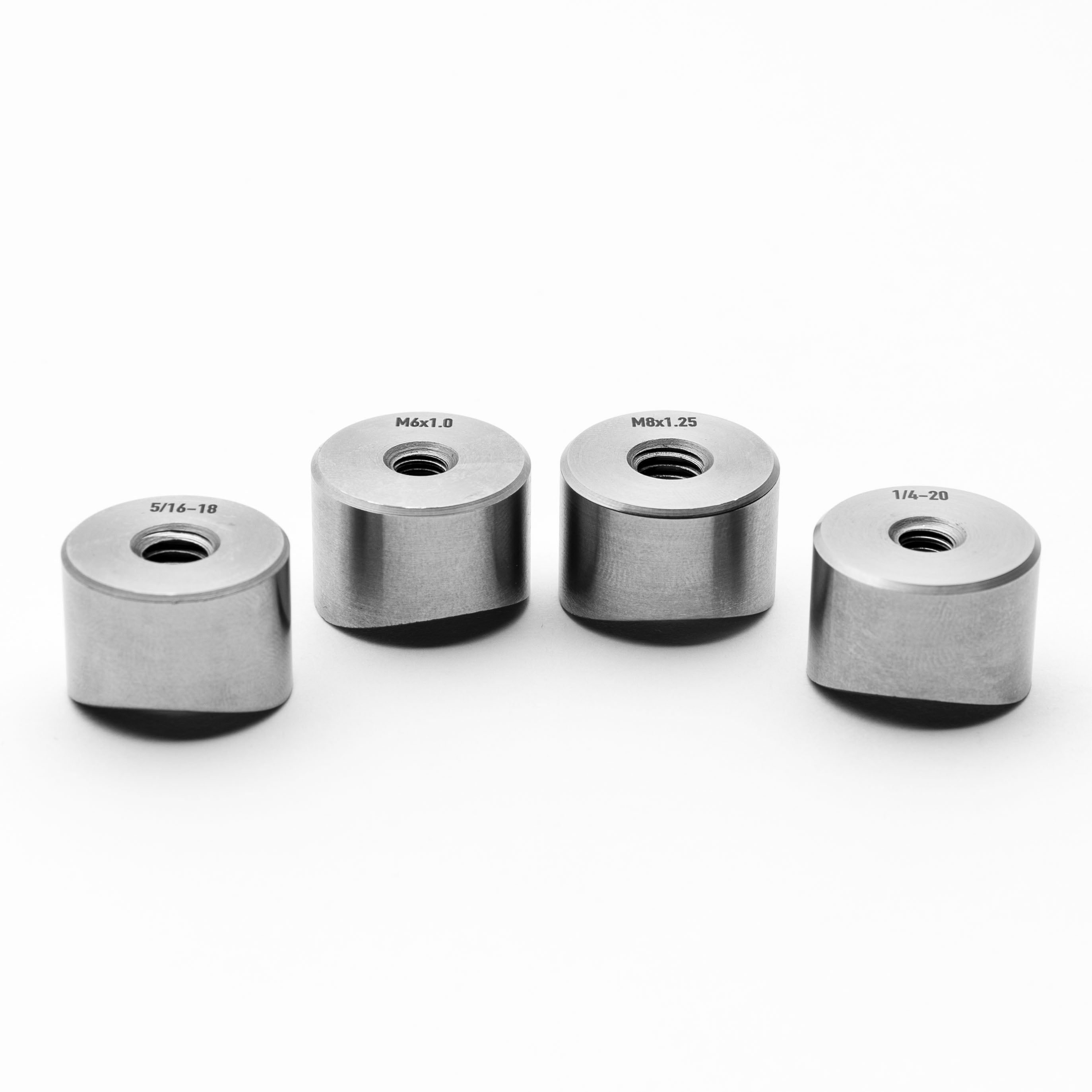 Four coped weld bungs with thread sizes on a white background