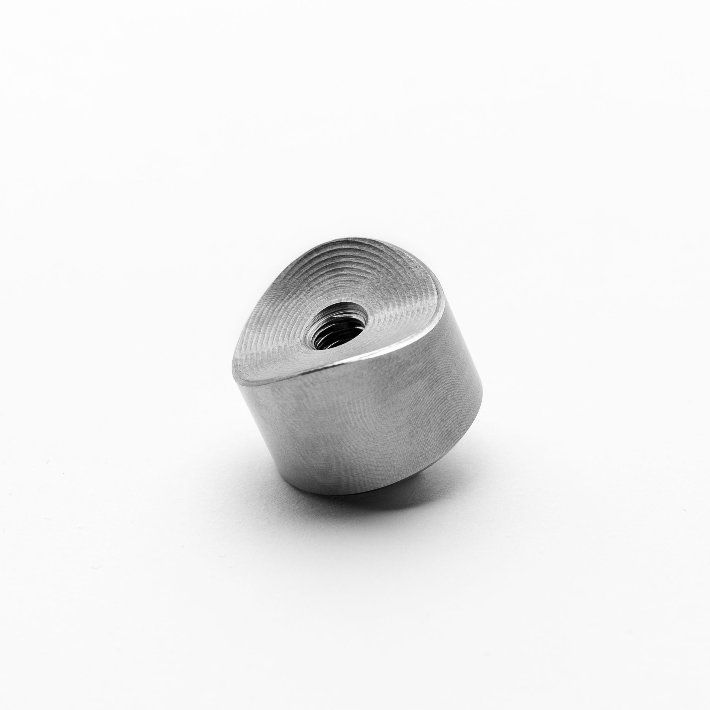 Metallic cylindrical object with threaded end on a white background