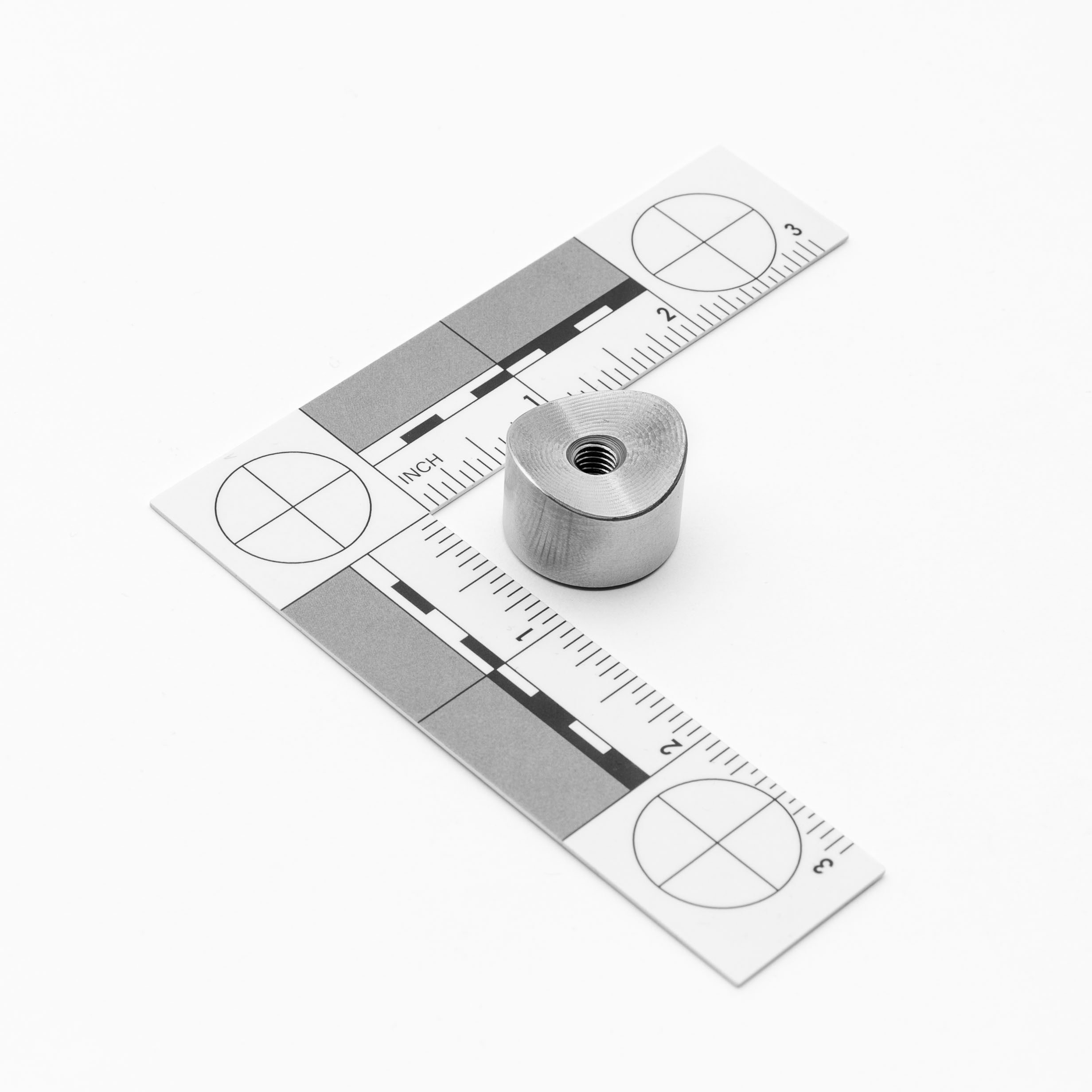 Metallic weld bung a ruler with measurement markings